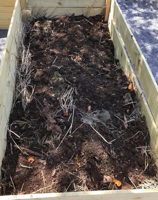 The last 4-6 inches should be a mixture of compost and topsoil.  More materials will need to be added each year as they break down, but you can just repeat the process.