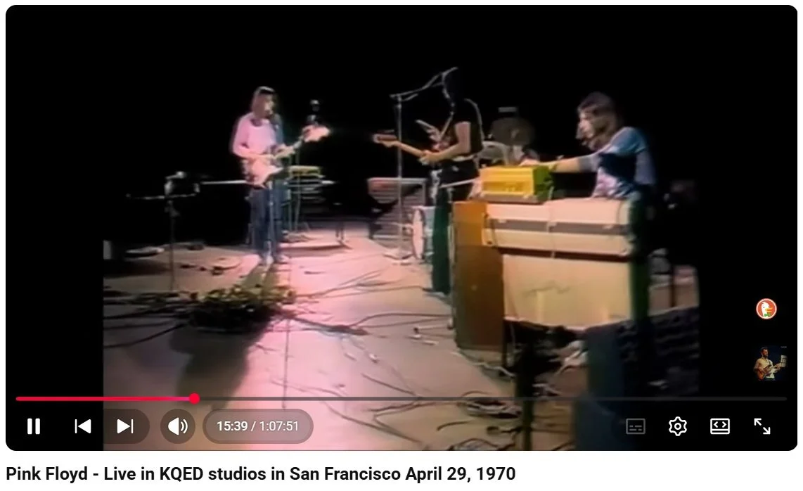 A live performance by Pink Floyd in KQED studios in San Francisco on April 29, 1970, showing band members with guitars and keyboards on stage, with equipment and cables visible.