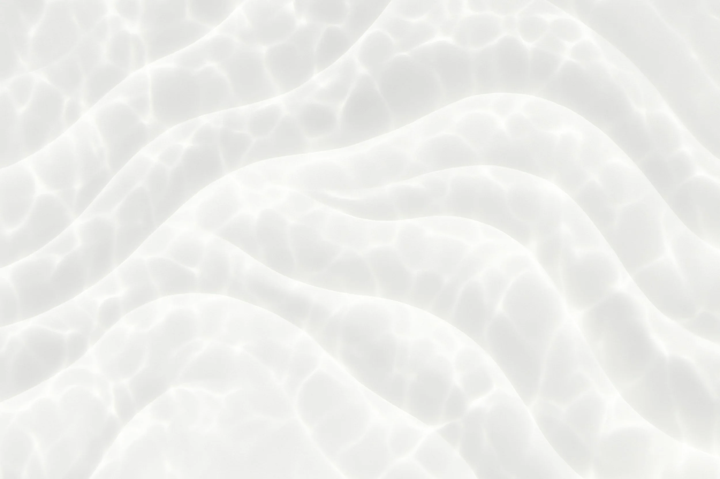 Close-up of a bright, white, rippling water surface with reflections and light patterns.
