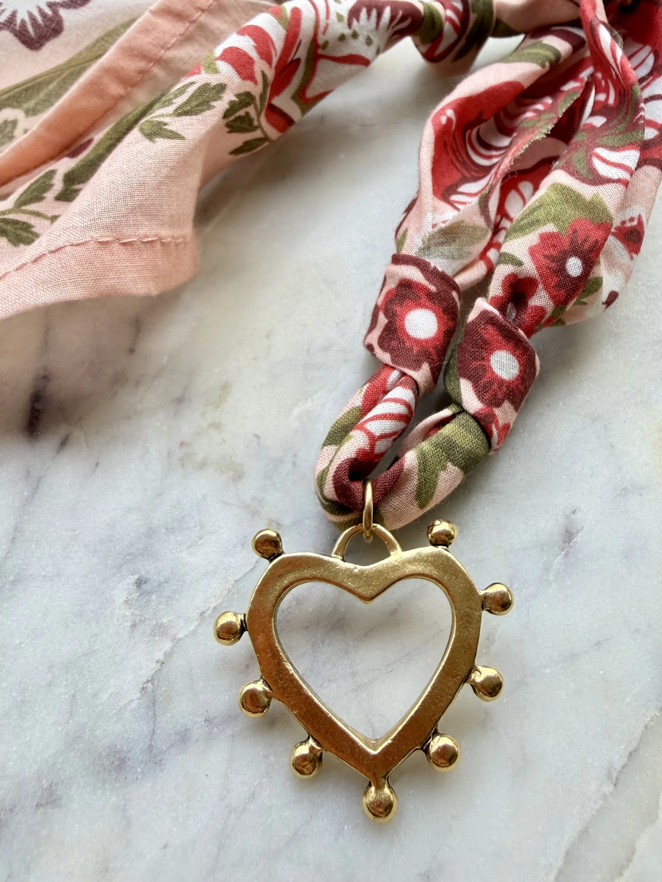Gold dotted heart charm on multicolored bandana