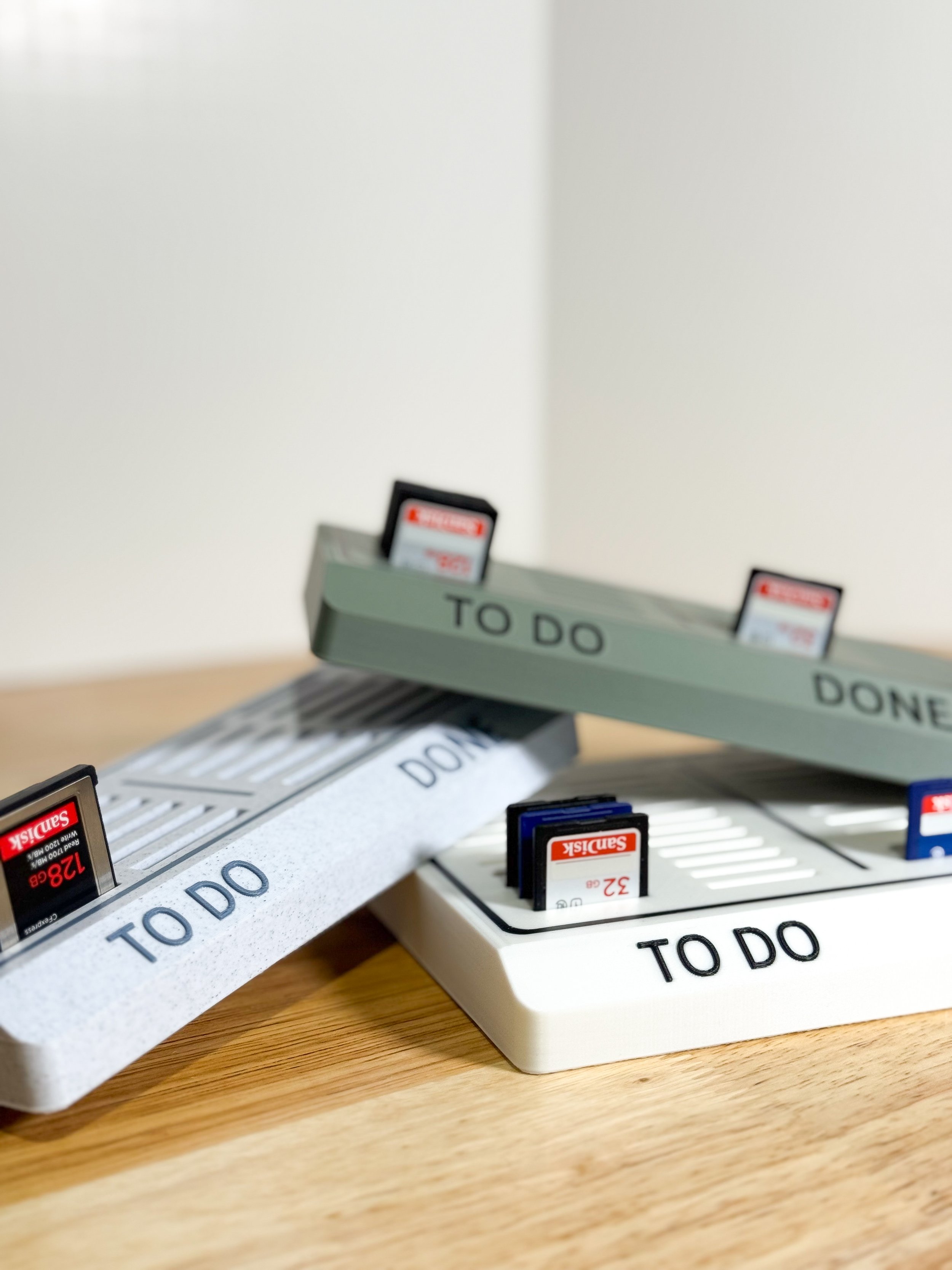 Desk organizer labeled "TO DO" with SD cards and glasses inside.