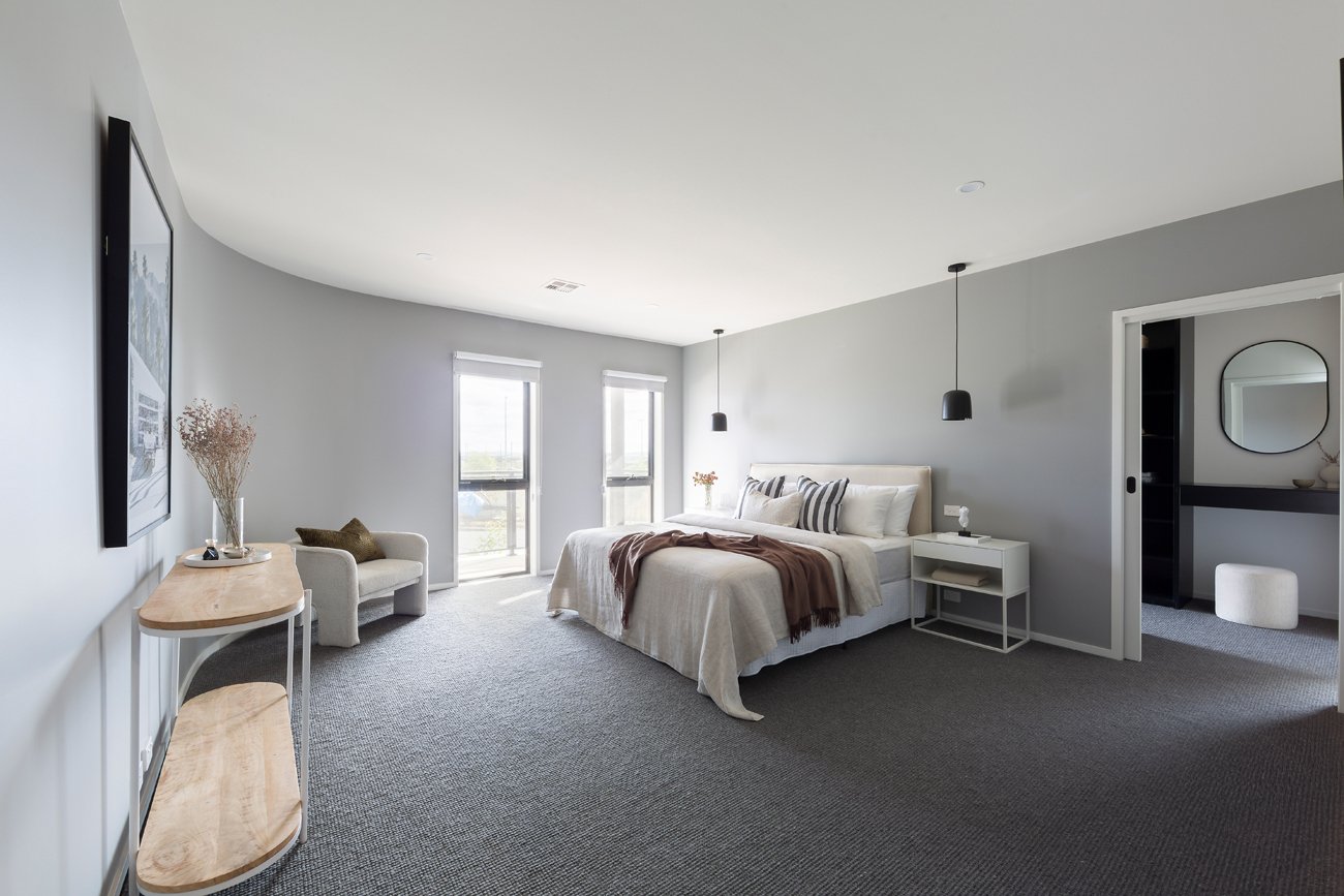 Large master bedroom with curved wall, walk in robe and ensuite by Banksia Projects