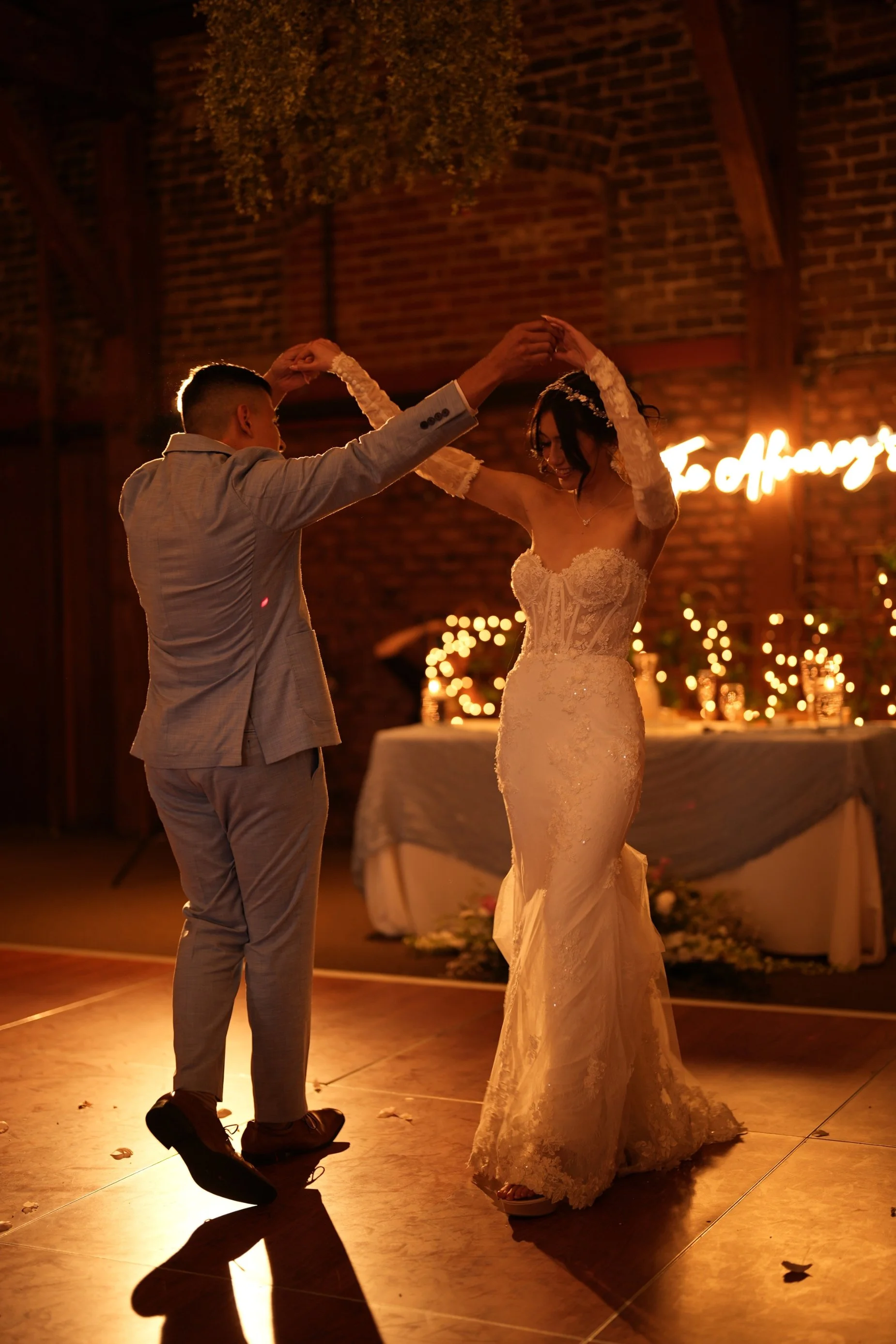 bride and groom dancing in the glowing lights.jpg