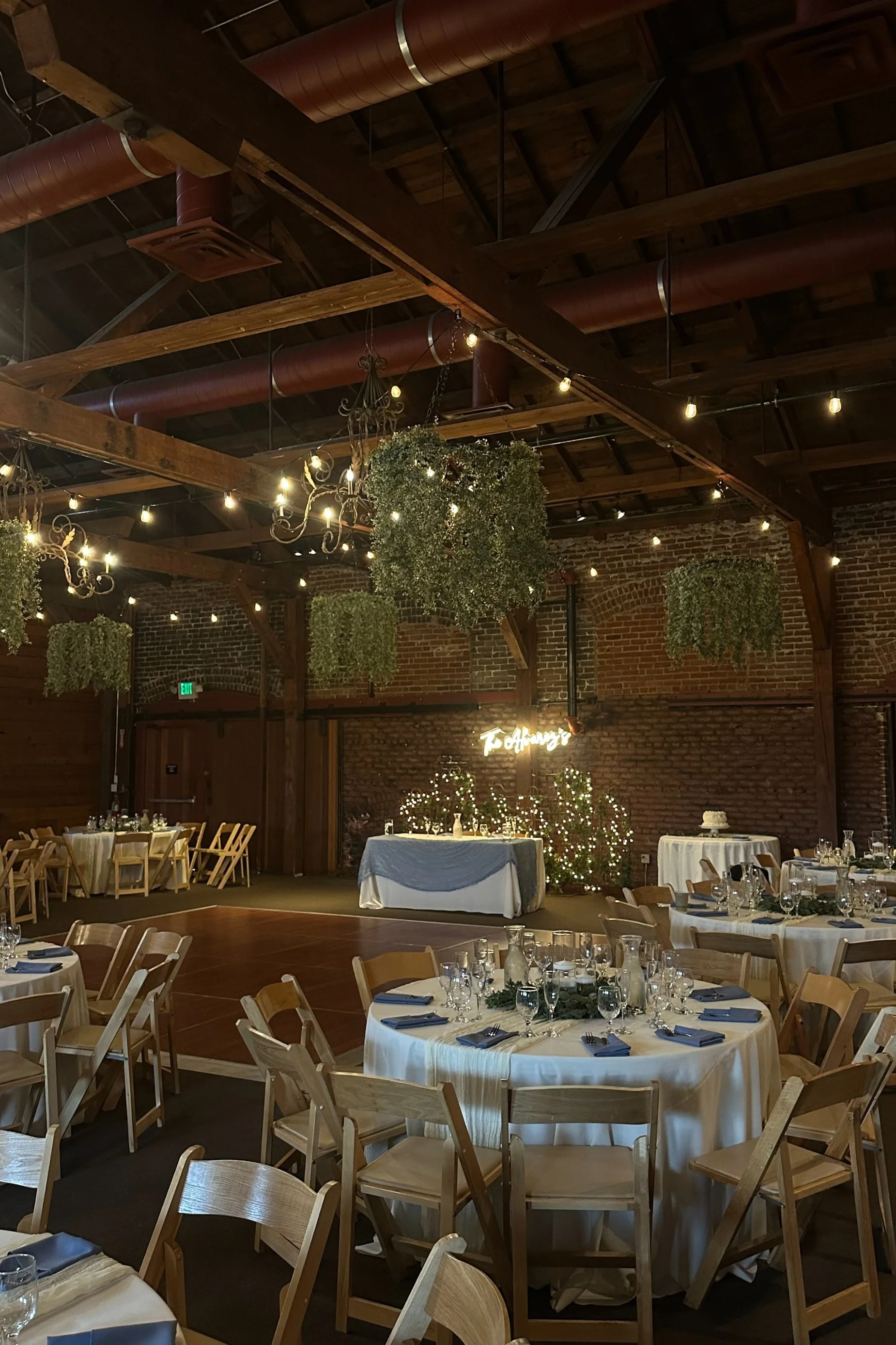 reception setup for wedding with glowing lights and romantic atmosphere in a industrial venue.jpg