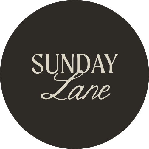Logo with the words 'Sunday Lane' in white on a black circular background.
