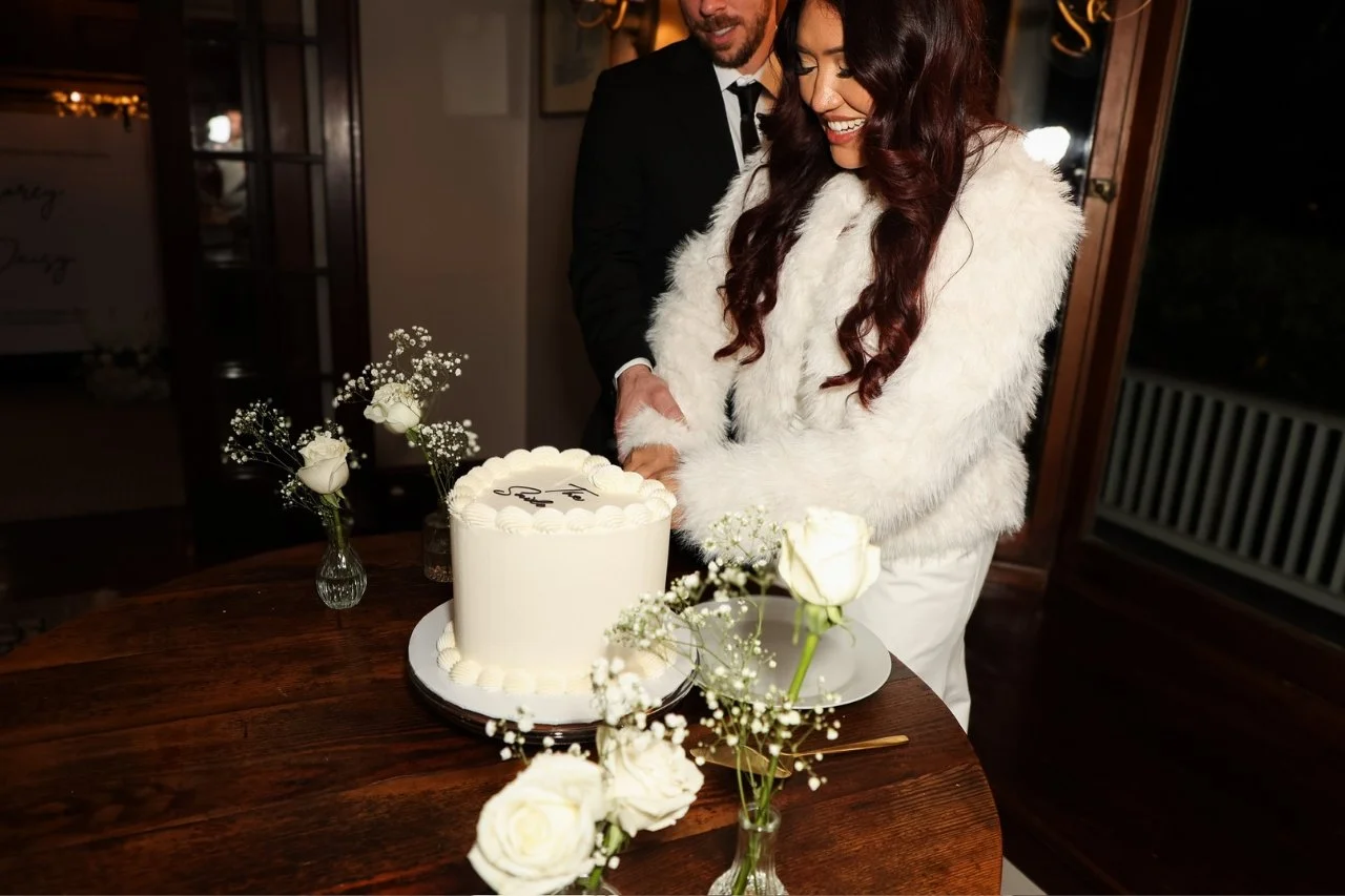 bride and groom cutting heart shaped wedding cake.jpg