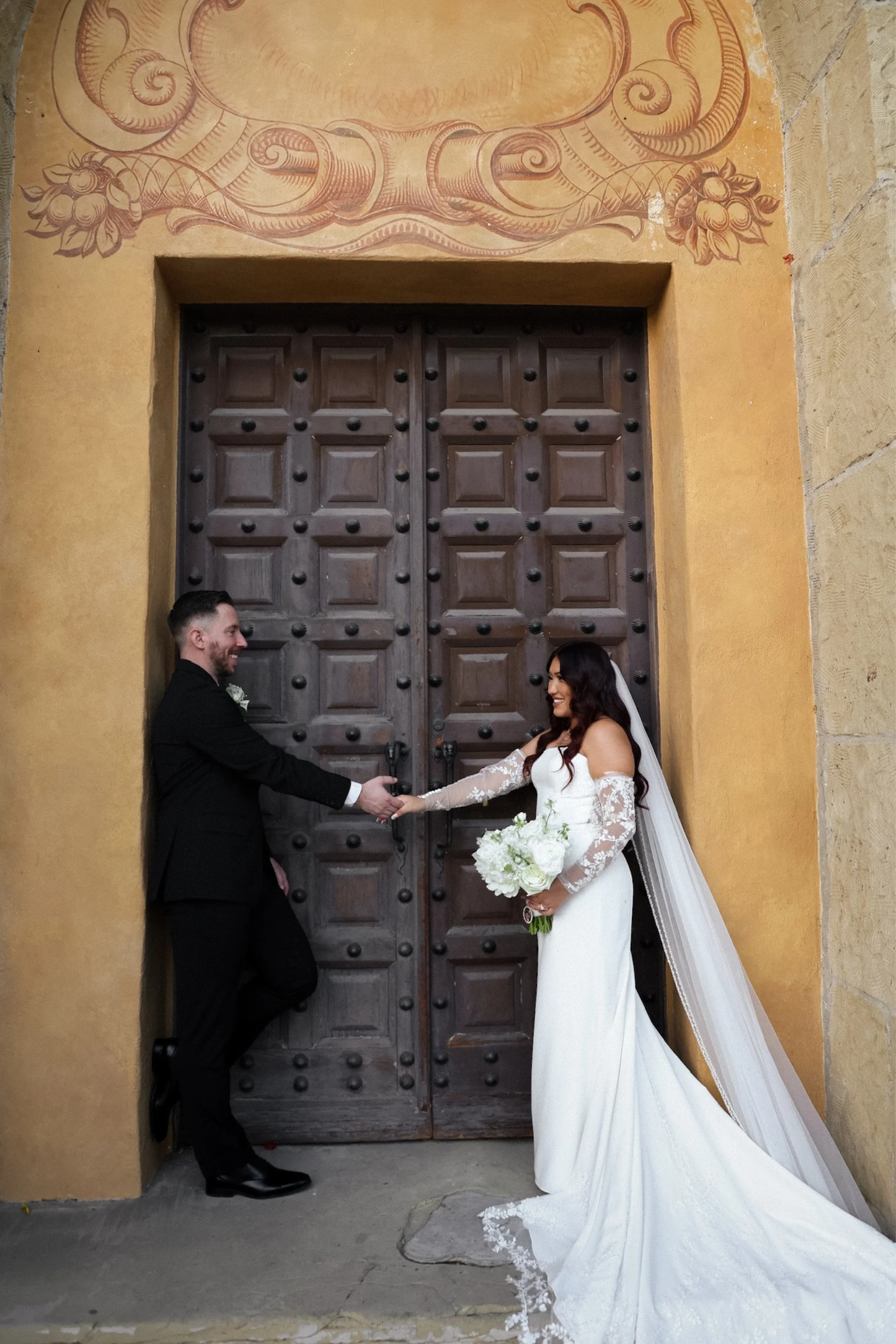 bride groom outside ceremony venue doors.jpg