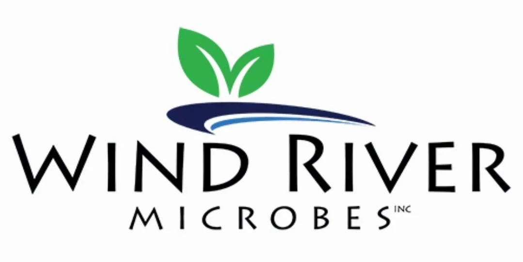 Logo for Wind River Microbes featuring green leaves, blue wave, and black text.