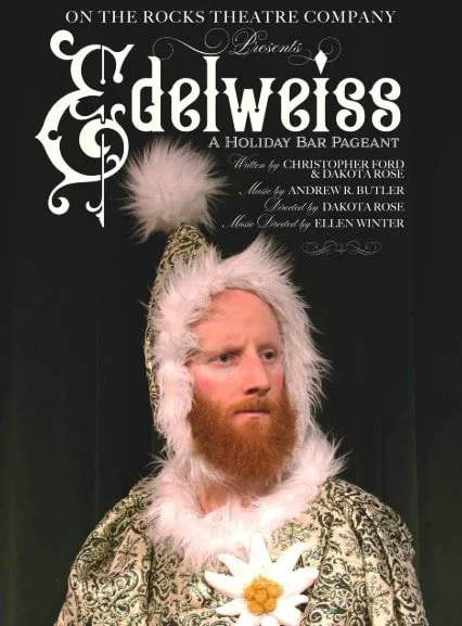 Promotional poster for the theater production 'Edelweiss' by On the Rocks Theatre Company, featuring a man dressed in a regal costume with a white feathered hat and a daisy flower, on a dark background.