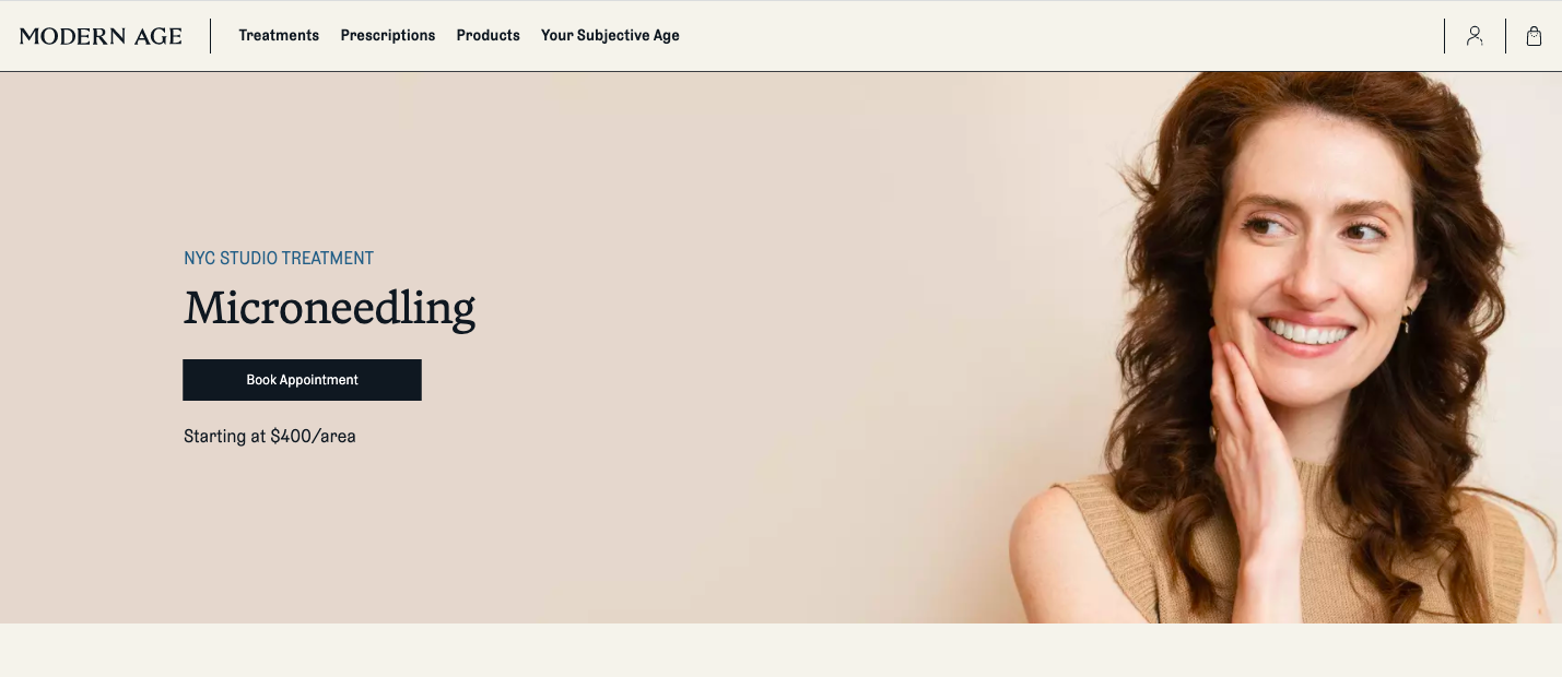 A woman with long, curly brown hair smiling and touching her face, on a beige background, part of a website promoting microneedling treatments.