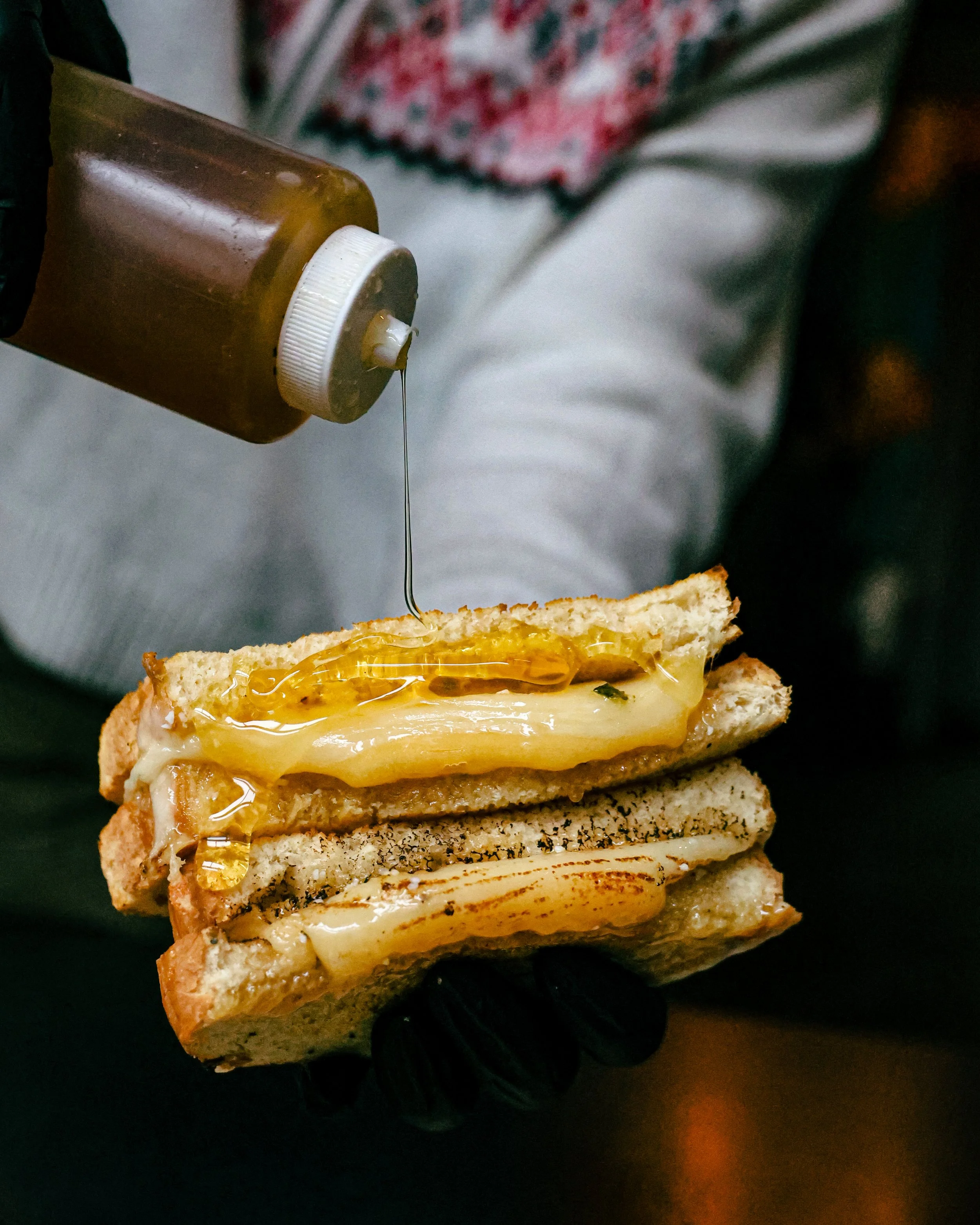 Bartender pouring sauce over a grilled sandwich at Locus café Bellingham WA