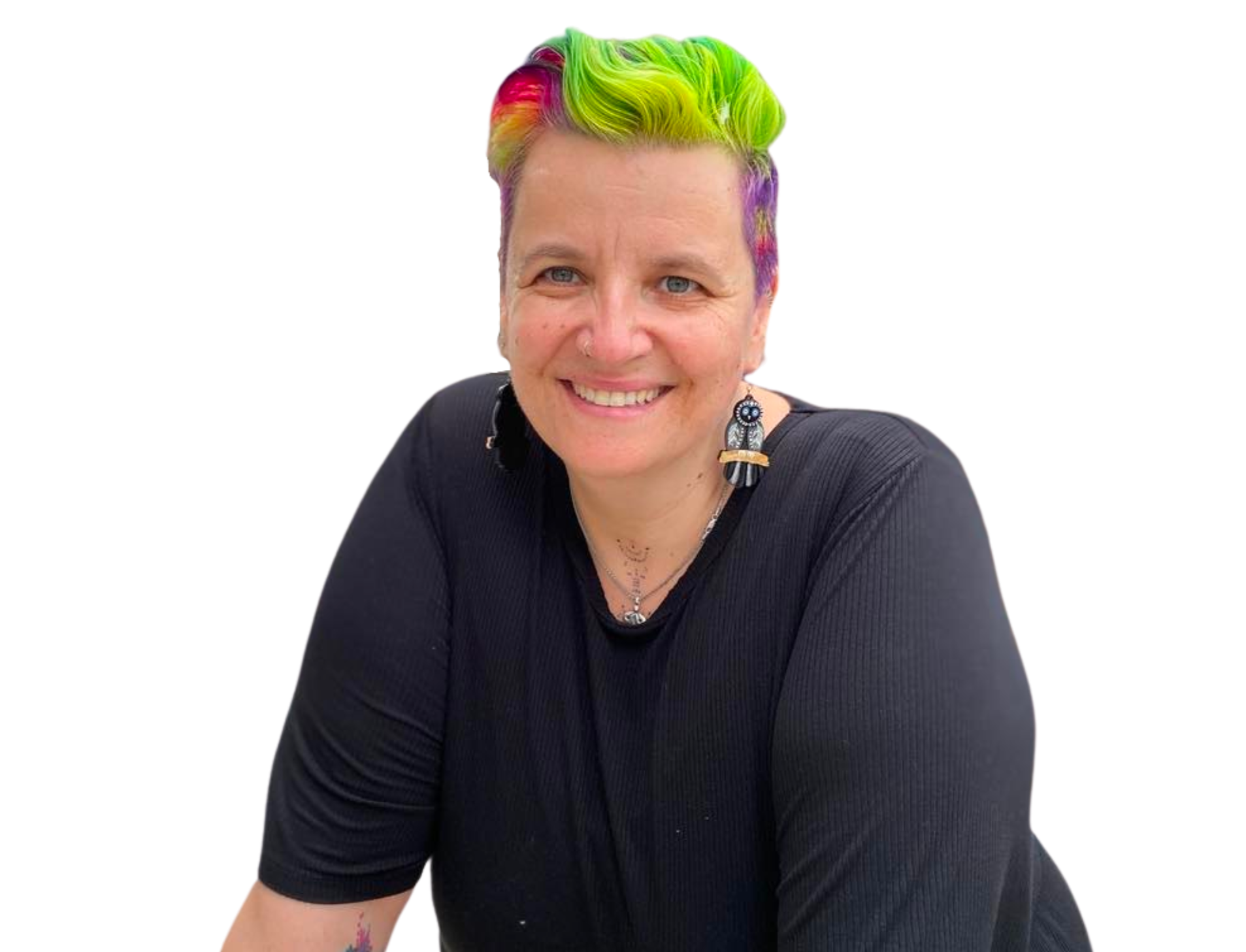 A smiling woman with short, colorful hair in shades of green, yellow, pink, and purple, wearing a black shirt and distinctive owl-shaped earrings.