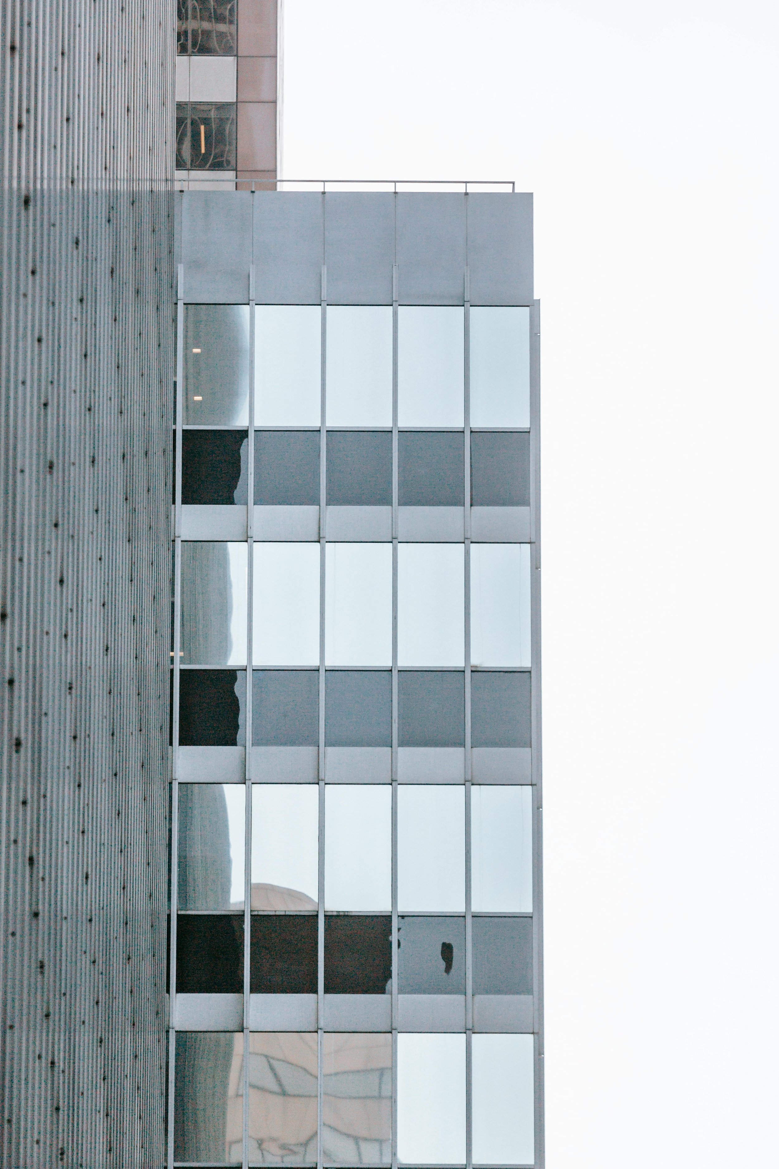 Close-up of a modern glass skyscraper exterior highlighting architectural project delivery