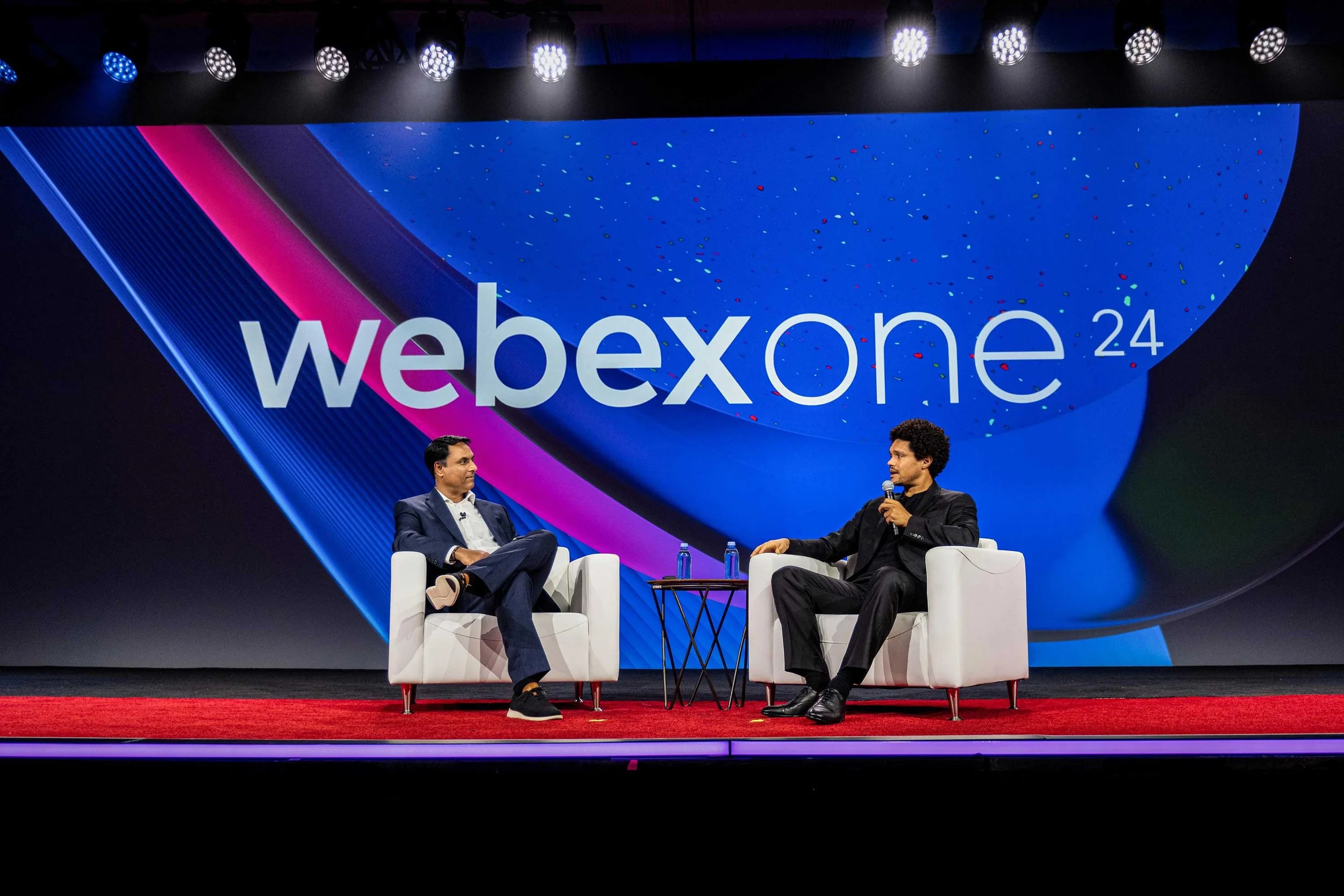 Two speakers in conversation on stage at WebexOne 2024.