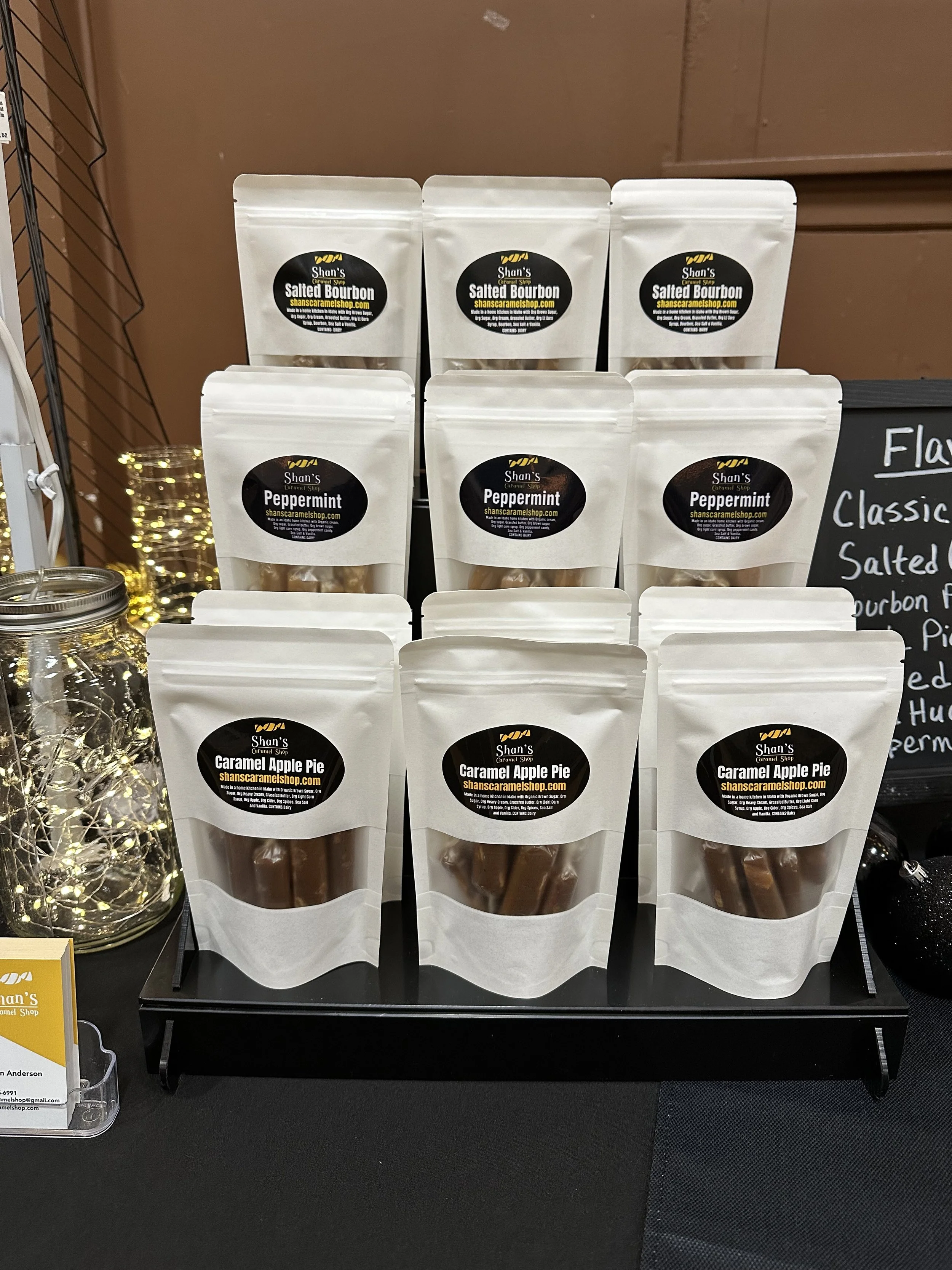 Display of packaged salted bourbon, peppermint, and caramel apple pie candies from Shan's Caramel Shop.