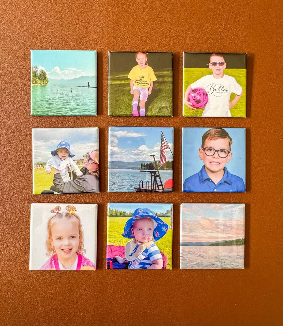 A 3x3 grid of nine canvas prints on a brown wall, featuring pictures of children, landscapes, and outdoor scenes.