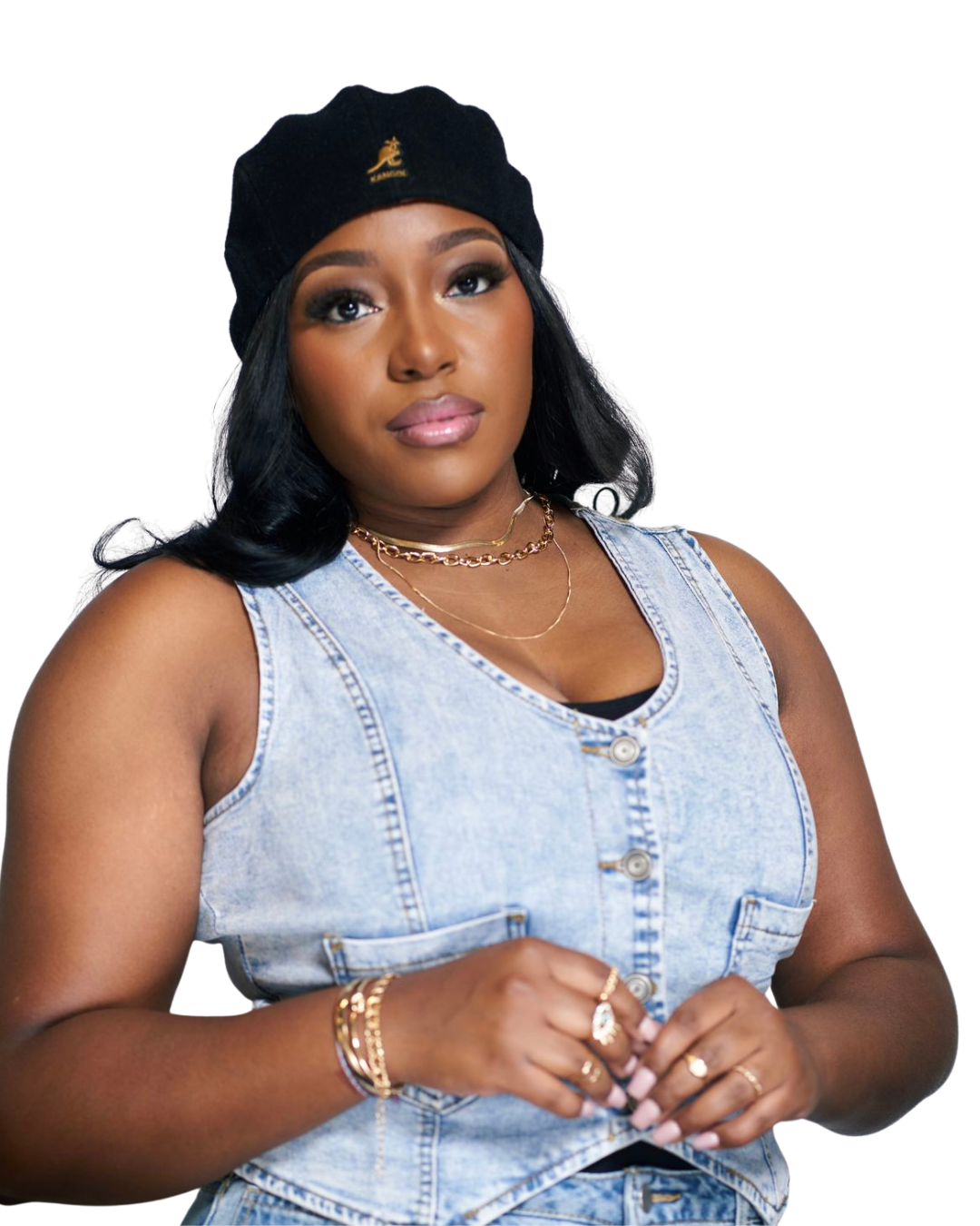 A young woman with long black hair wearing a black beret, denim sleeveless vest, and gold jewelry.