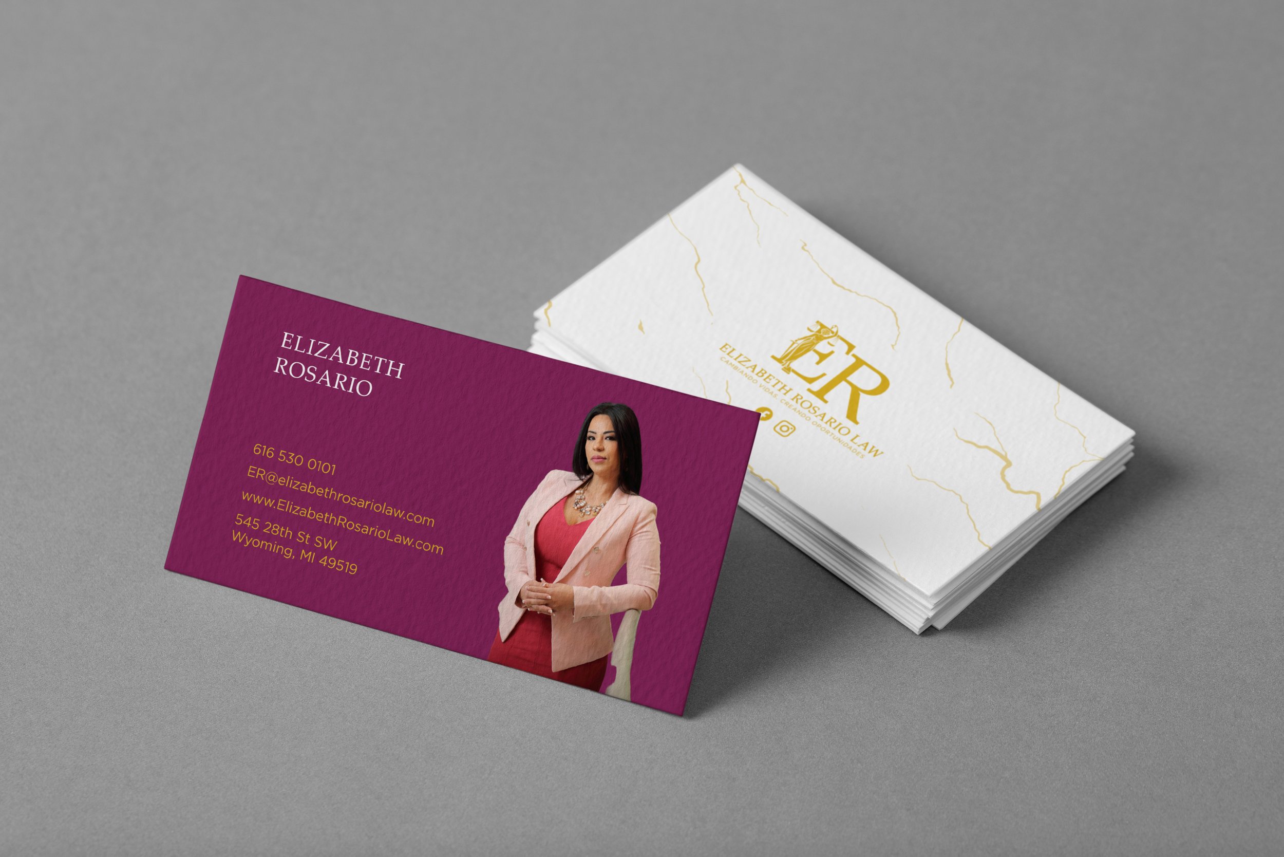 Business cards for Elizabeth Rosario Law, featuring a woman in a pink blazer and a pink dress on a purple card, and a white card with gold logo and marbled design.