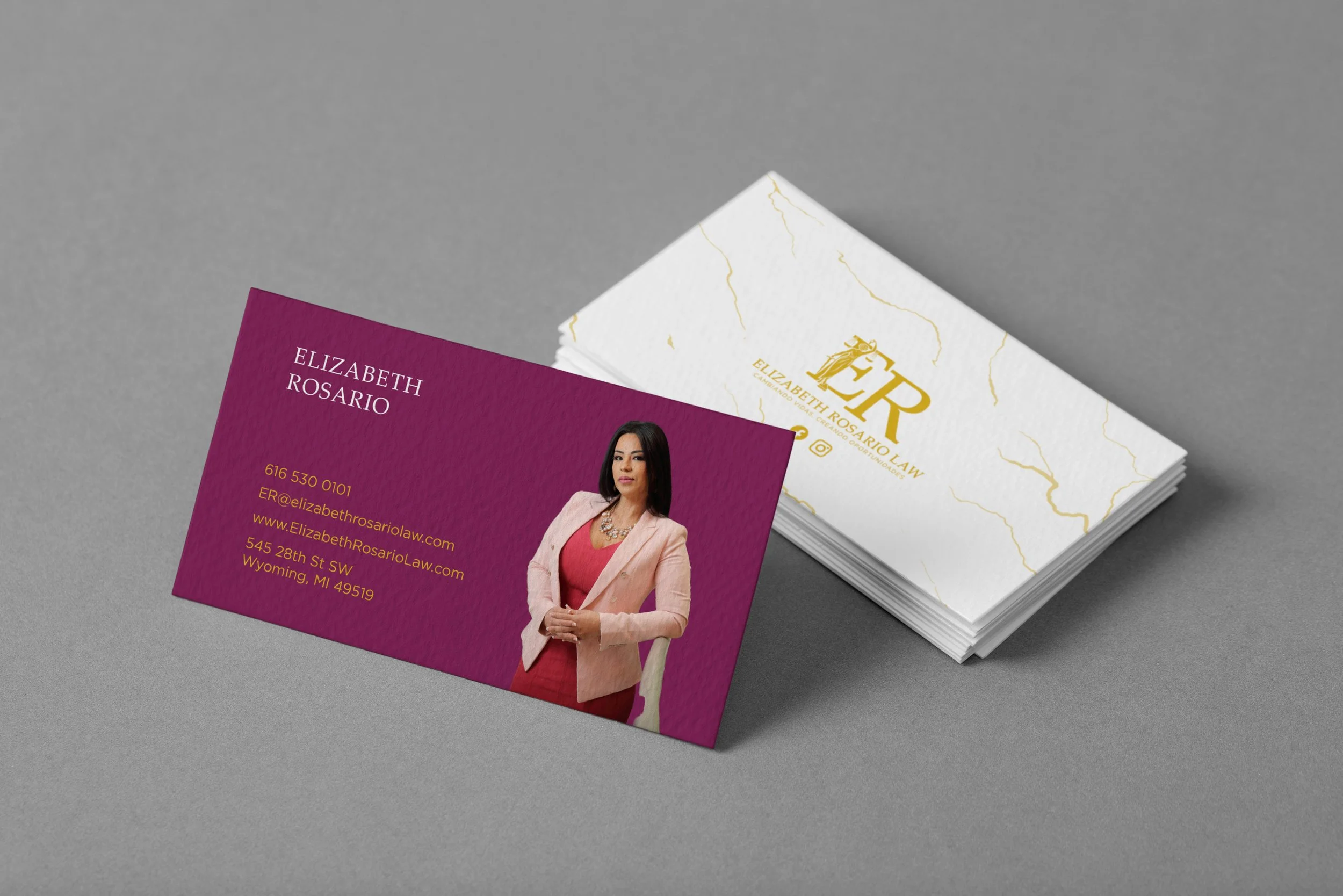 Business cards for Elizabeth Rosario Law, with a maroon card featuring a photo of Elizabeth Rosario, her name, contact information, and a white card with gold and black logo design.