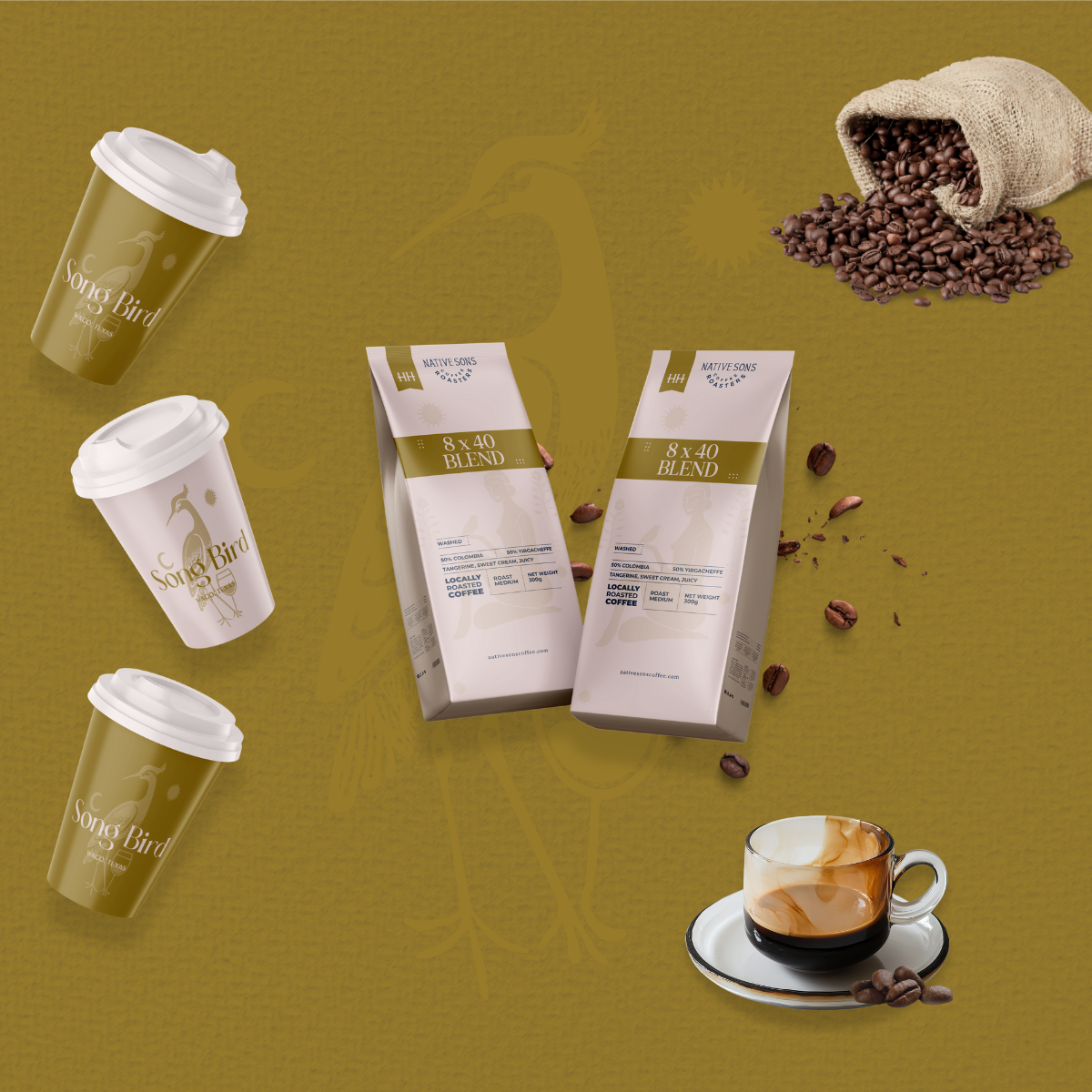 Coffee cups with 'Song Bird' logo, bags of native coffee blend, spilled coffee beans, and a cup of coffee on saucer against a yellow background.