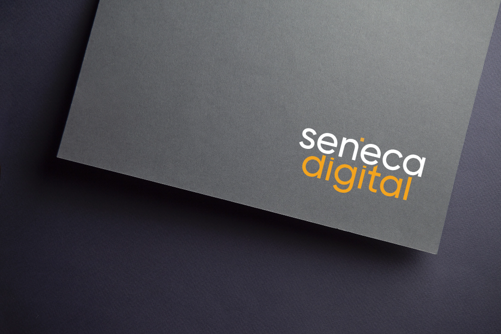 A gray envelope with the words "senecca digital" printed on it in white and yellow text.