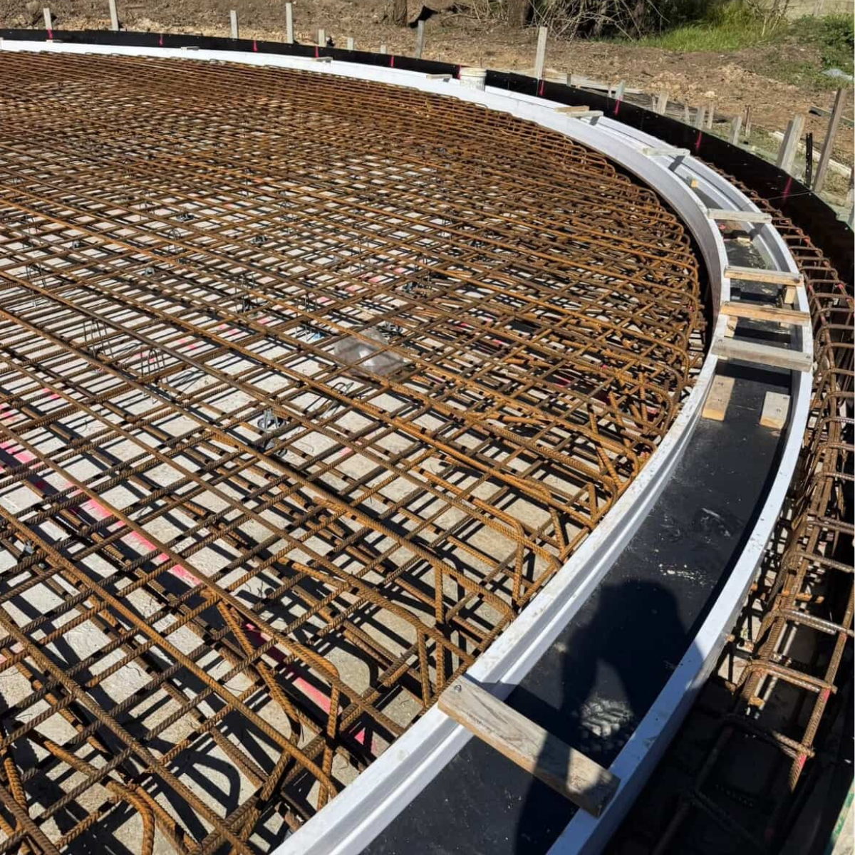 Curved Concrete Formwork And Steel Reinforcement Installed By Bulty’s Concreting On A Sunshine Coast Civil Project, Demonstrating Precision Structural Preparation, Steel Fixing And Large-Scale Slab Construction.