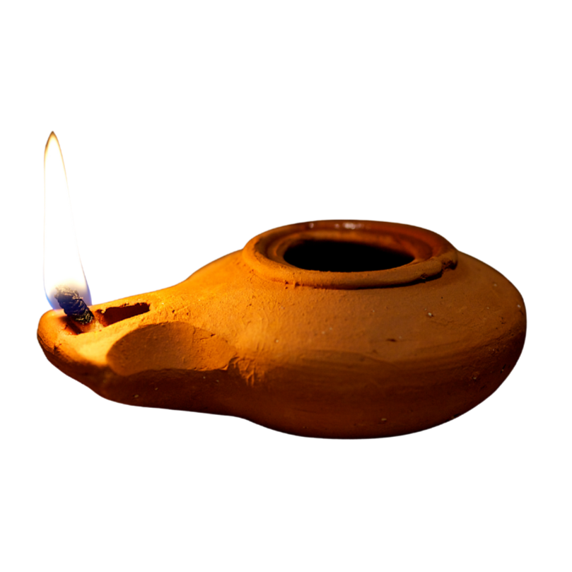 A traditional clay oil lamp, lit with a small flame, against a black background.