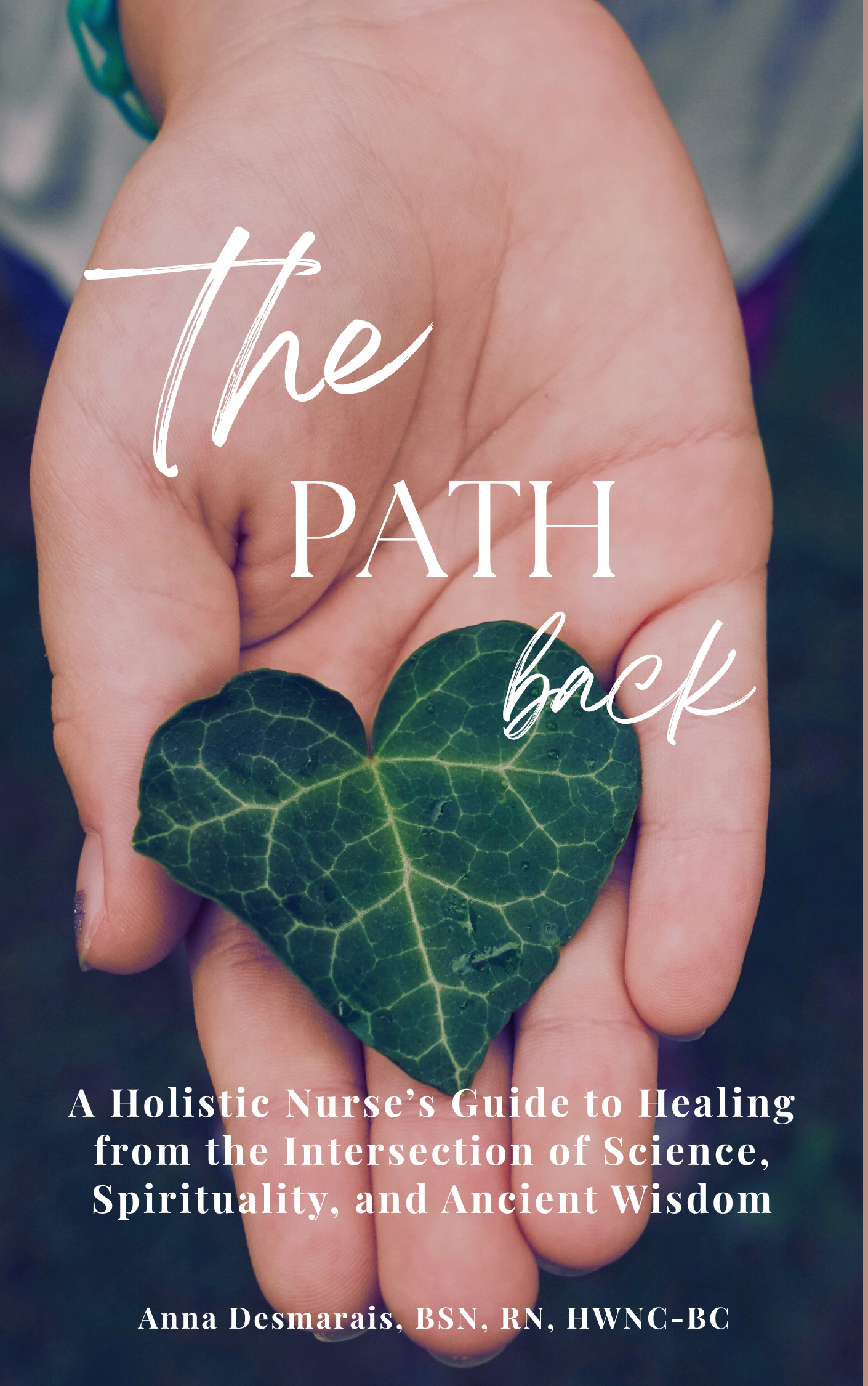 Book cover titled 'The Path Back' with a hand holding a green, heart-shaped leaf, and the subtitle 'A Holistic Nurse's Guide to Healing from the Intersection of Science, Spirituality, and Ancient Wisdom' by Anna Desmarais, BSN, RN, HWNC-BC.