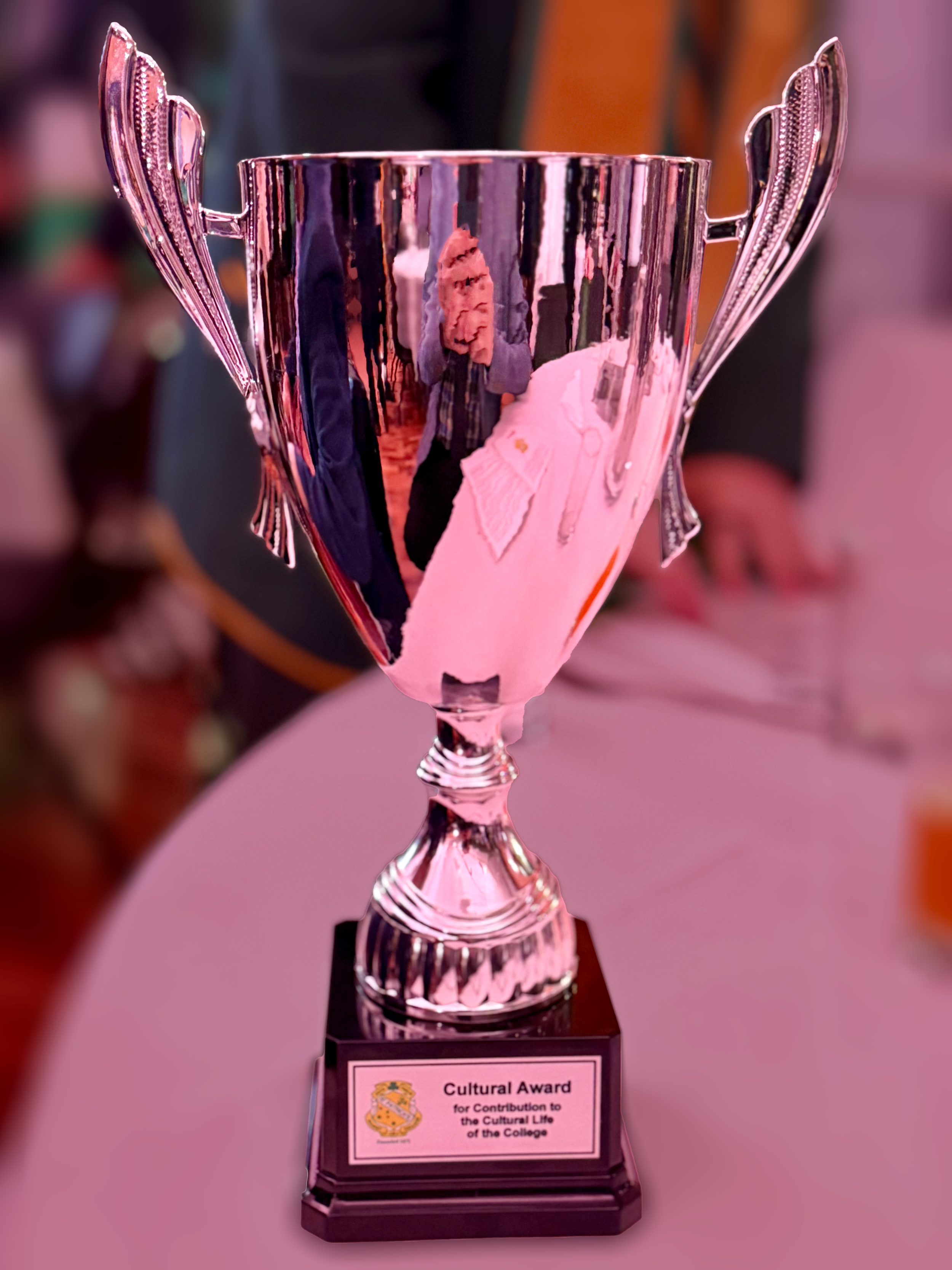 Silver trophy with two handles and a black base, engraved with a plaque reading 'Cultural Award for Contribution to the Cultural Life of the College'.