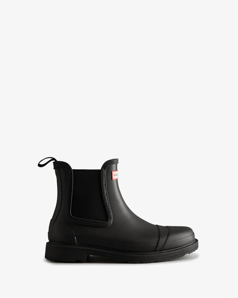 Black rain boot with elastic side panel and pull loop at the back, branded with a label on the upper side.
