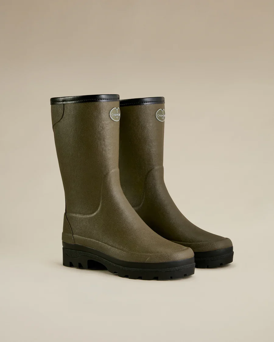 A pair of olive green rain boots with black soles and trim, featuring a small logo near the top.
