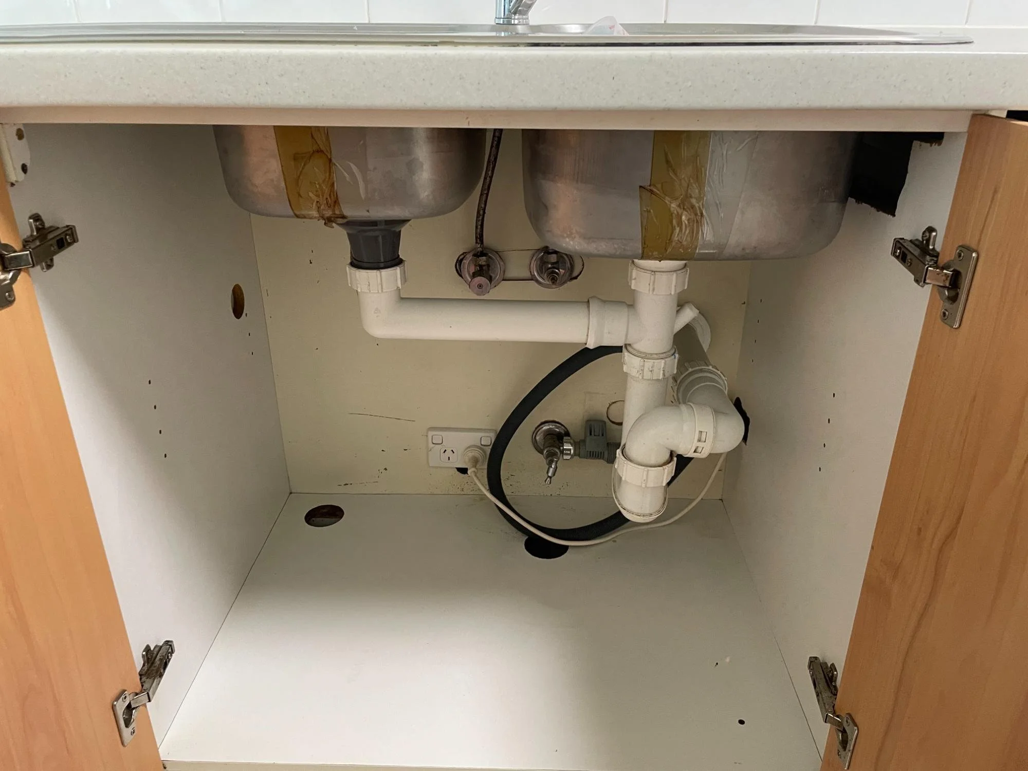 Cupboards under laundry sink after deep cleaning by Kat Clean Sydney, NSW