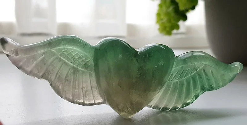 Het soefi symbool als gevleugeld hart in groen glas.