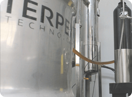 Industrial stainless steel extraction equipment with Terp Tech branding in processing facility