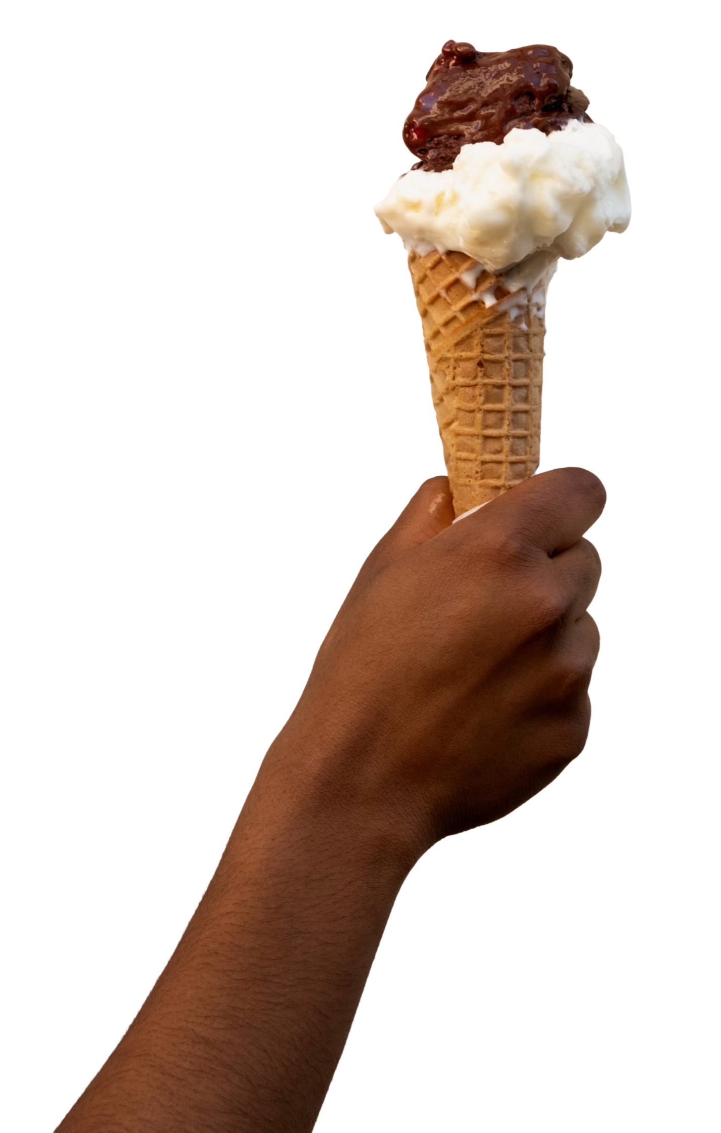 Hand holding a waffle cone with two scoops of ice cream, one vanilla and one chocolate  Florence, Tuscany, Italy..