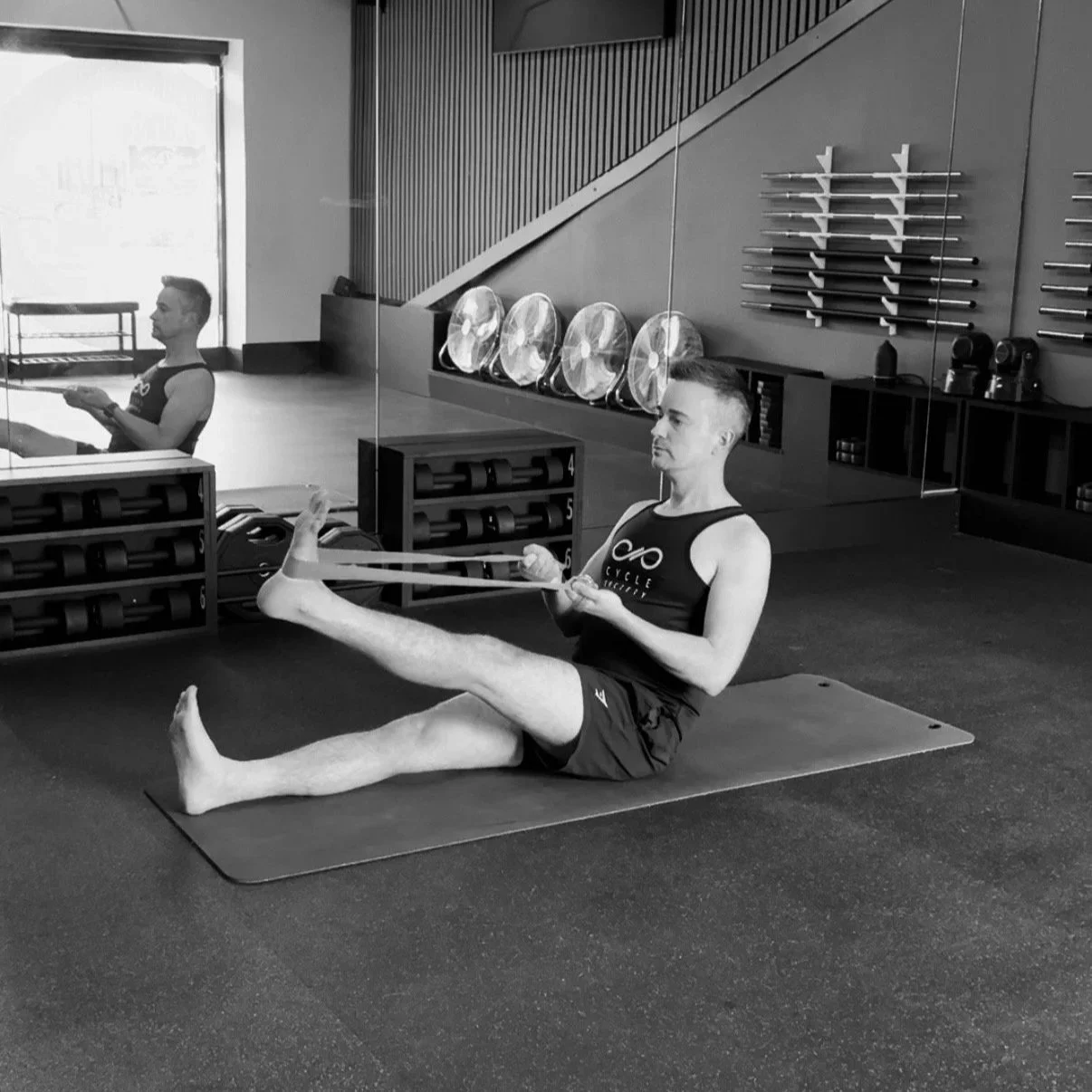 Fitness Coach performing a hamstring stretch