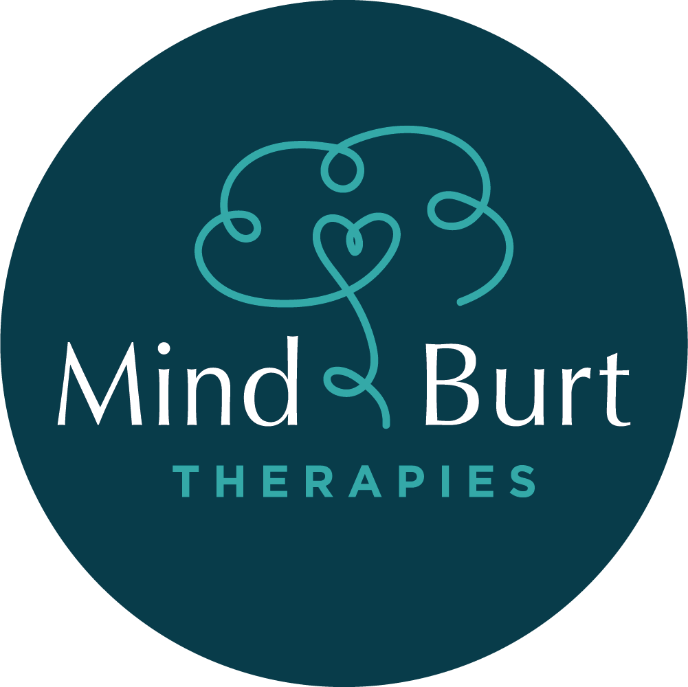 Logo for Mind&Burt Therapies featuring a stylised line drawing of a brain with a heart shape in the centre, on a dark blue circular background.