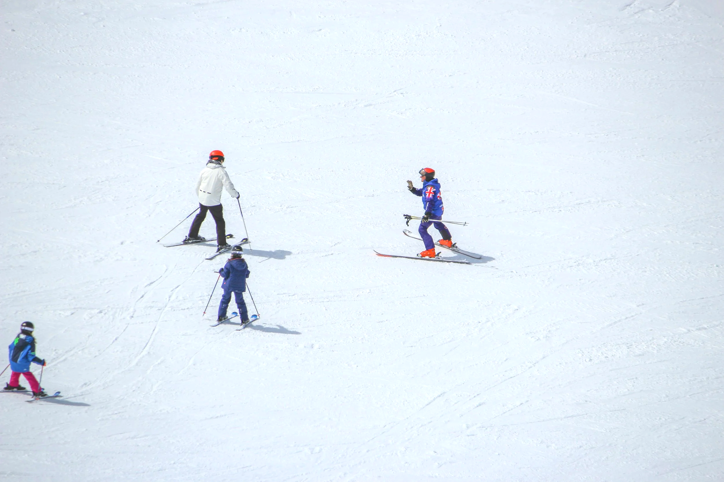 English ski instructor from the British Ski Center holding a family ski lesson