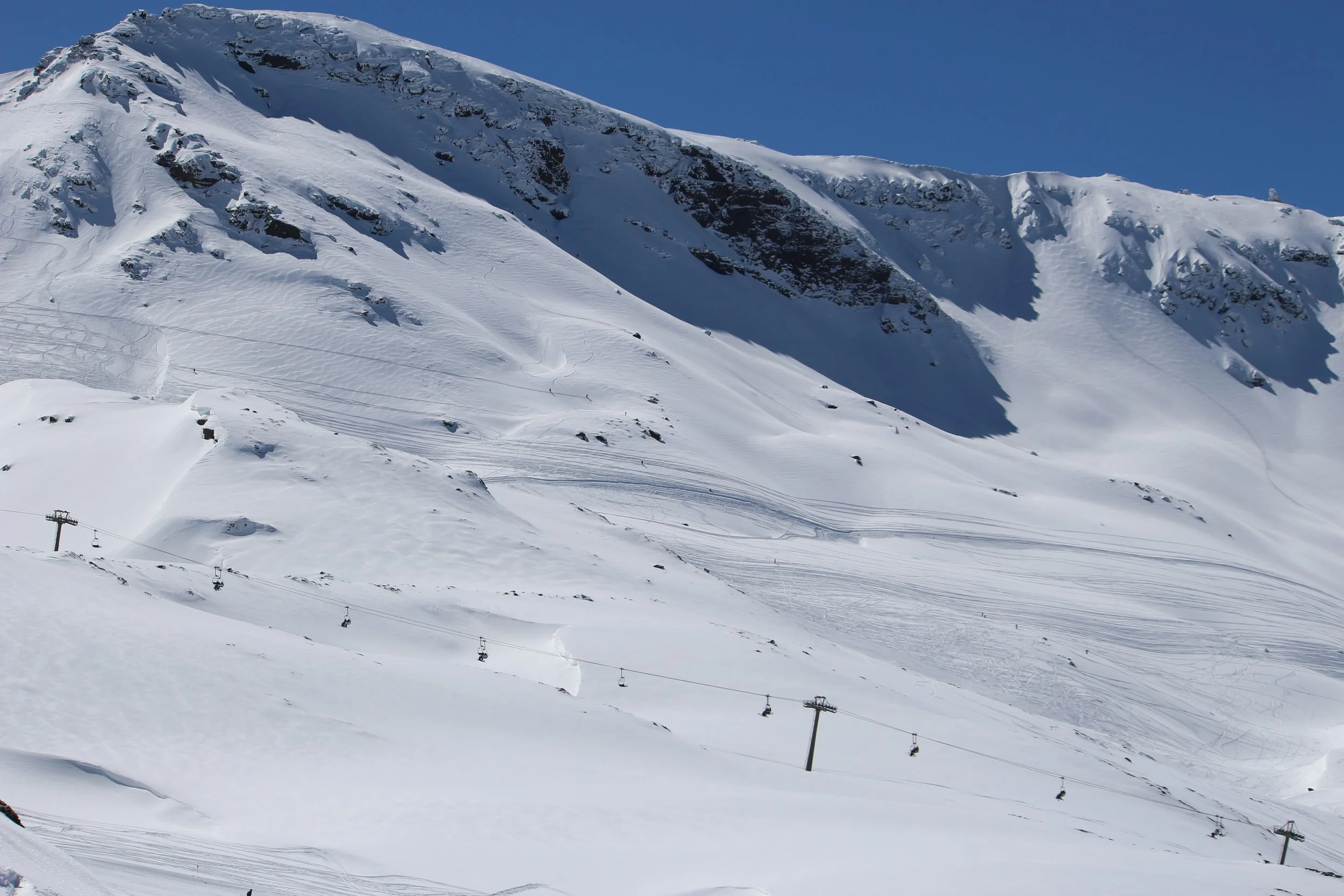 Laguna Area in Sierra Nevada on a snow-covered, sunny day with blue skies.