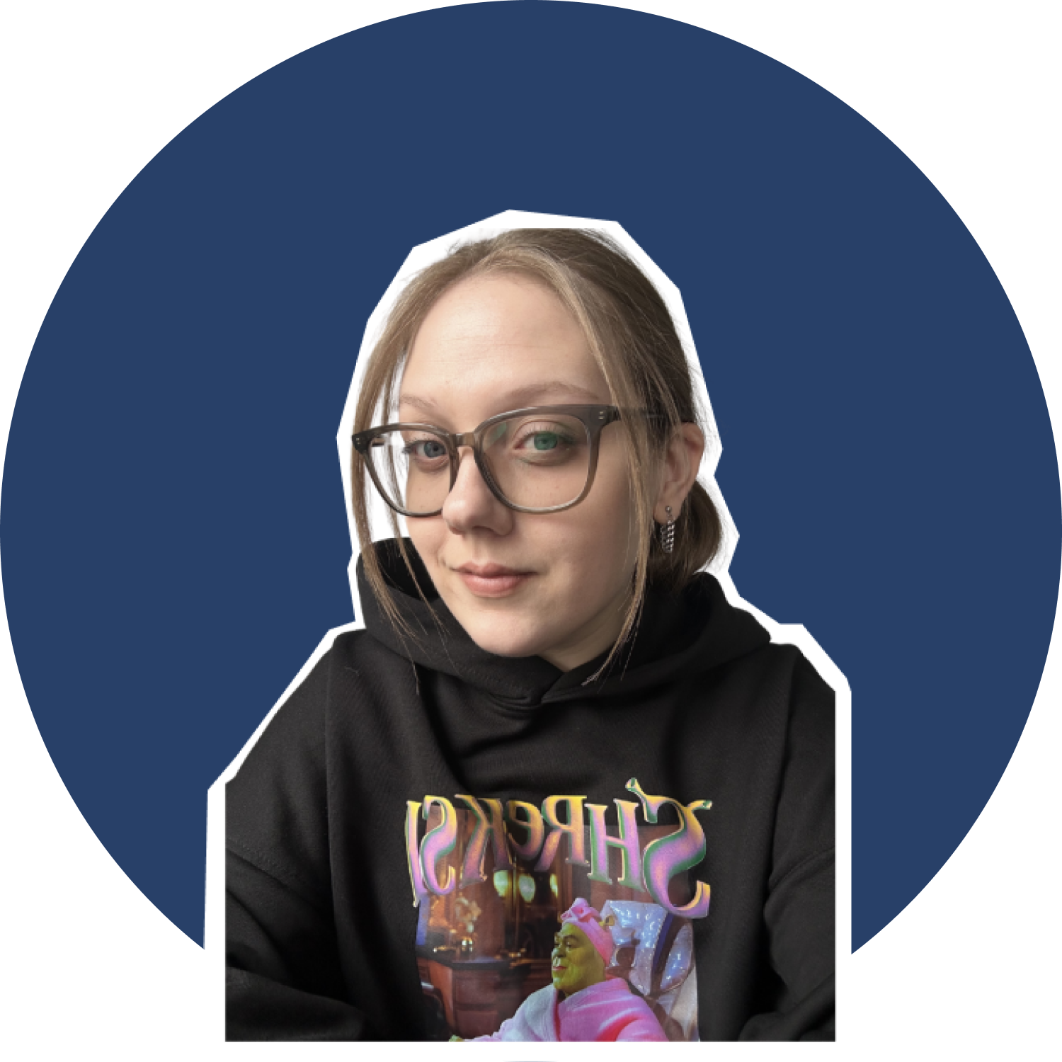 A young woman with light brown hair, glasses, and earrings, wearing a black hoodie and a graphic sweatshirt, posing against a dark blue background.