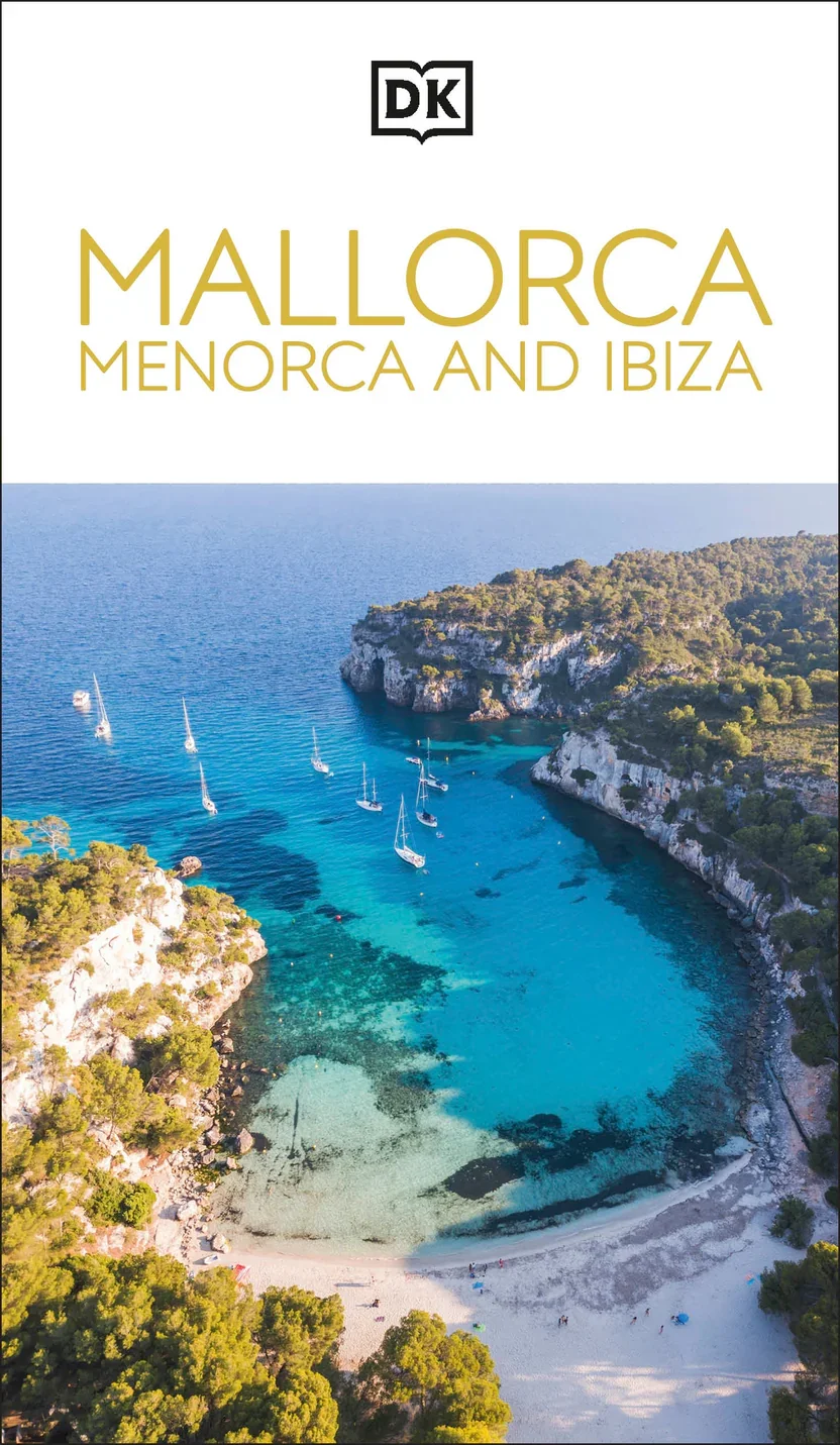 Cover of a travel guide titled 'Mallorca Menorca and Ibiza' with the DK logo at the top, featuring a scenic aerial view of a turquoise bay with sailboats, rocky cliffs, green vegetation, and a sandy beach.