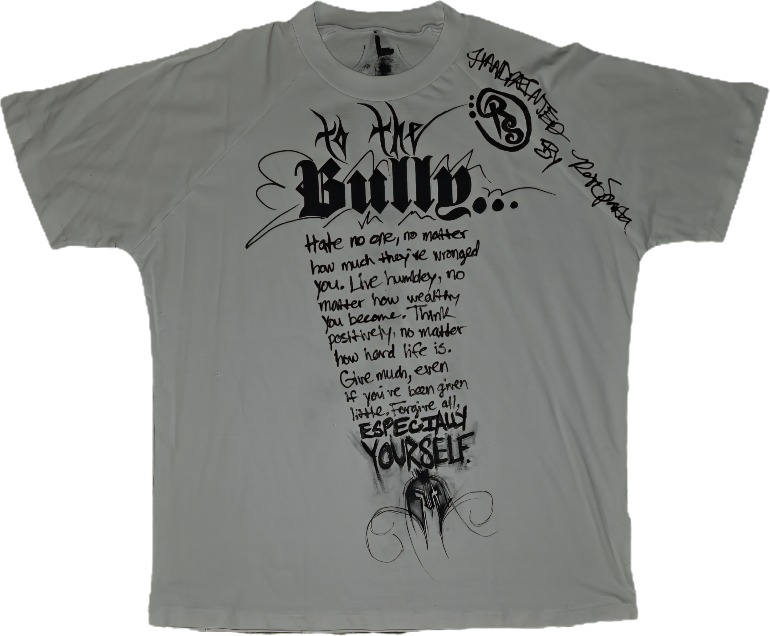 A white T-shirt with black graffiti-style text and drawings, including the phrase "BE BOLD" and an inspirational quote about overcoming hardships, with decorative swirls and a tribal design at the bottom.