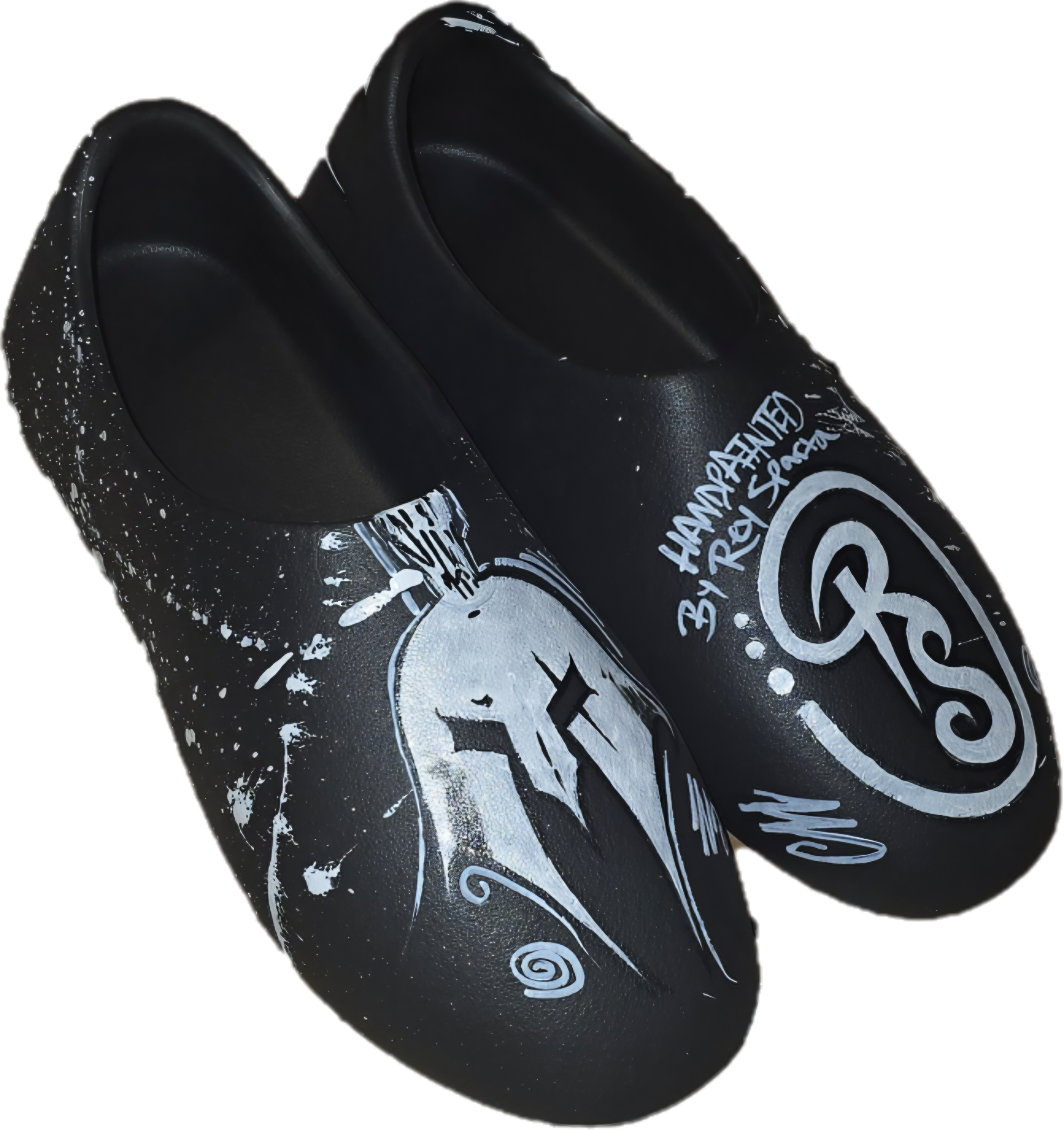 Black painted slip-on shoes with white graffiti-style artwork and text, including a stylized logo and a signature.