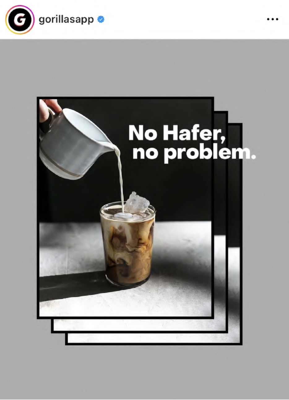 A glass of iced coffee with cream being poured in, with a dark background and a gray surface, accompanied by the text "No Hafer, no problem."