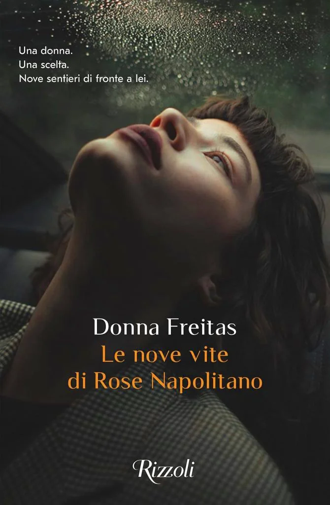 Cover of a book titled 'Le nove vite di Rose Napolitano' by Donna Freitas, featuring a woman with short brown hair leaning her head back, looking up with a thoughtful expression, rain droplets on a window in the background.
