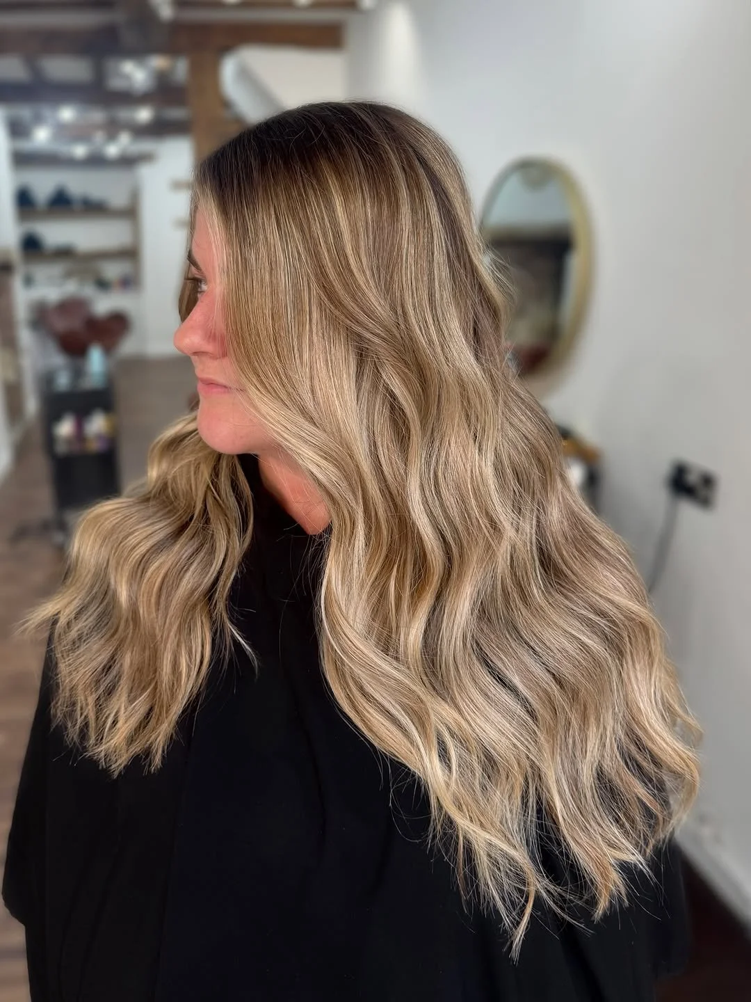 Warm sun-kissed blonde highlights applied using bespoke foil placement