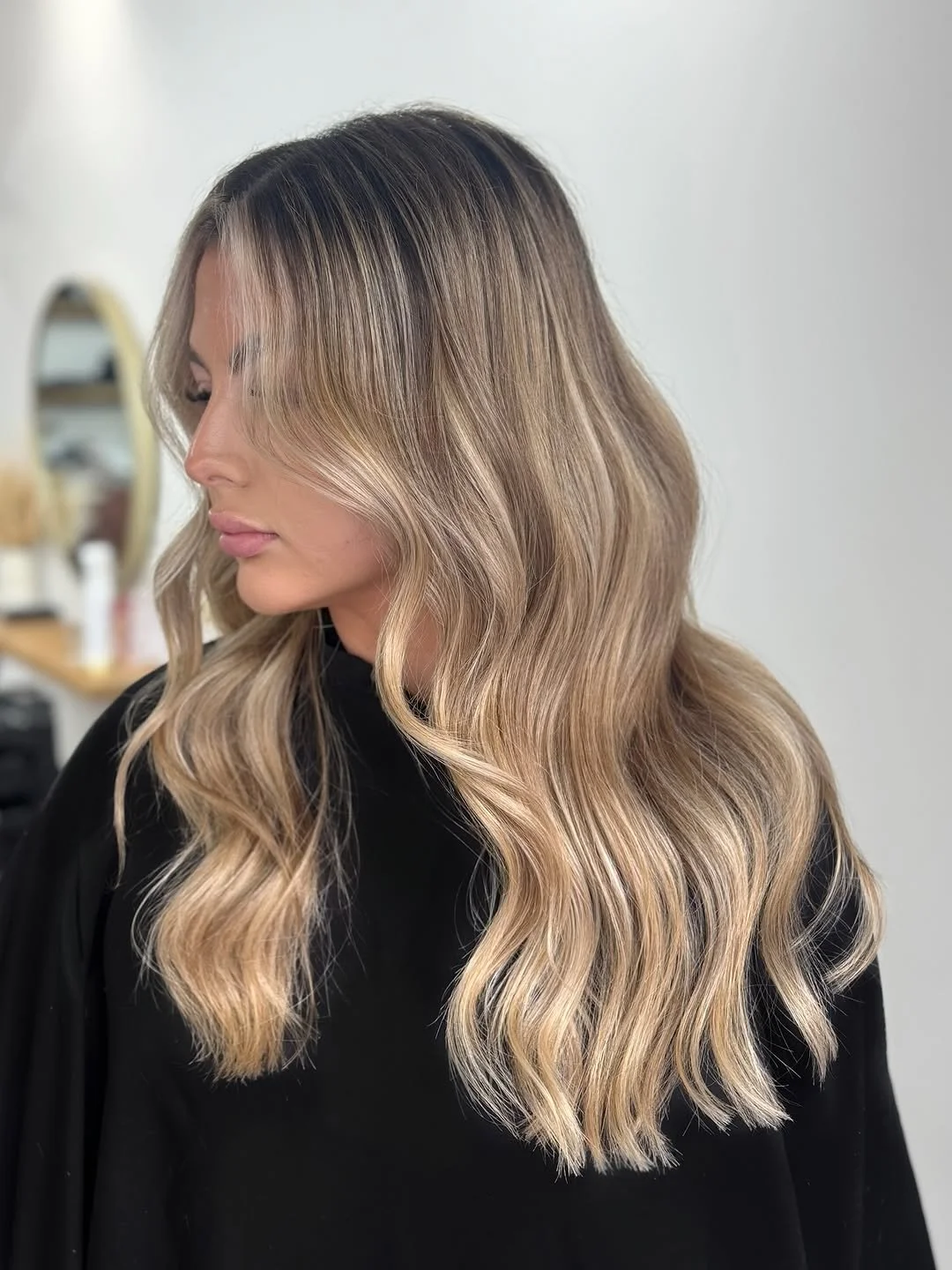 Soft balayage blonde finish with seamless blend and glossy shine