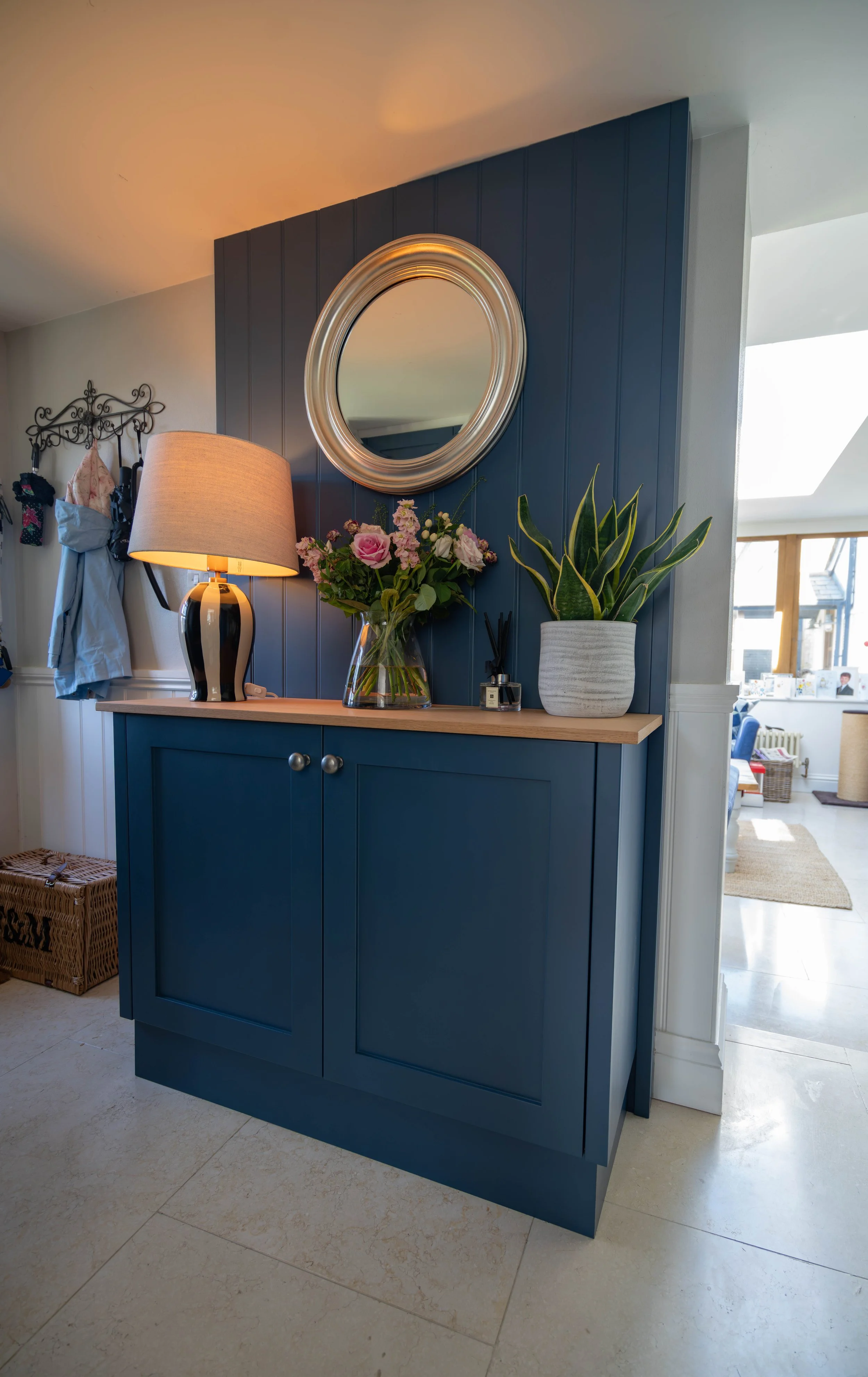 painted sideboard with tongue and groove panelling and round mirror