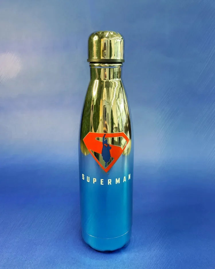A metallic water bottle with Superman logo and the word Superman on it, featuring a blue background.