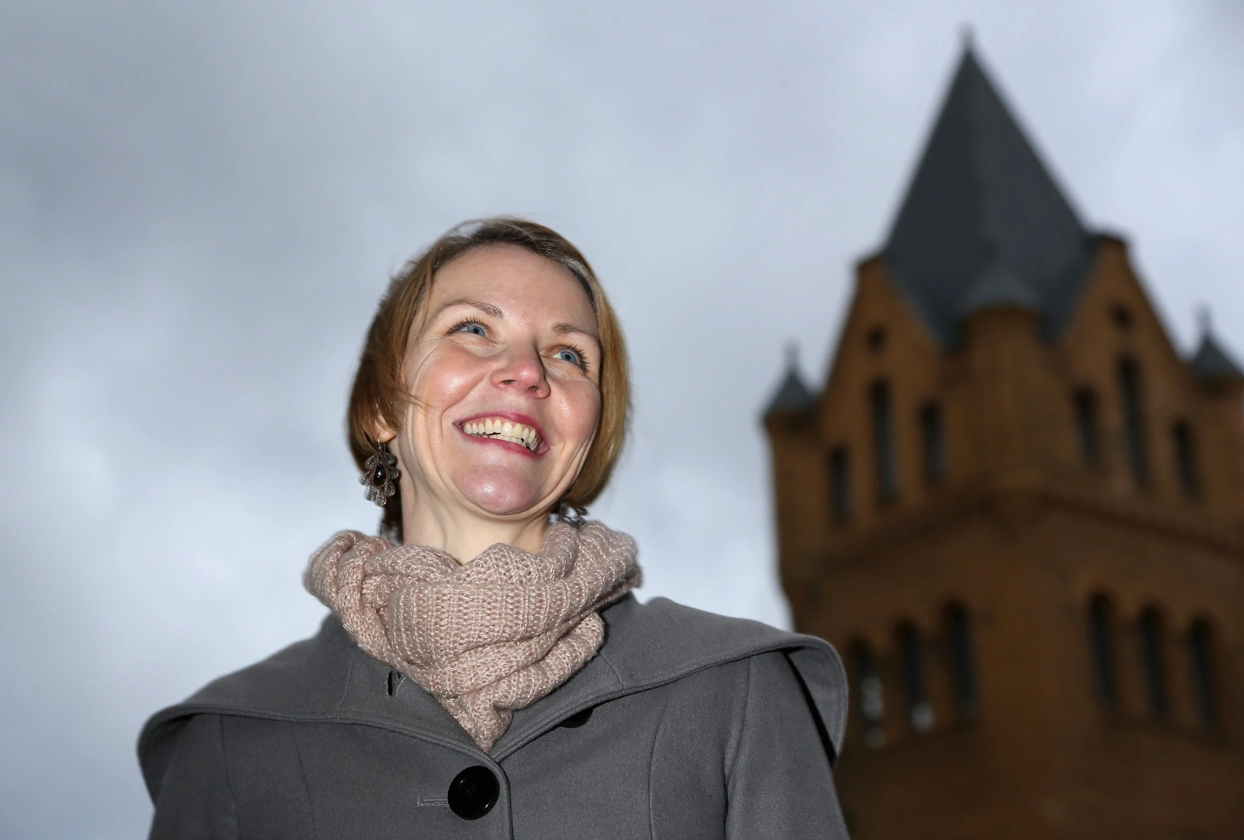 Courtney Tenz profile photo shows a woman in a winter jacket standing outside the culture brewery in berlin